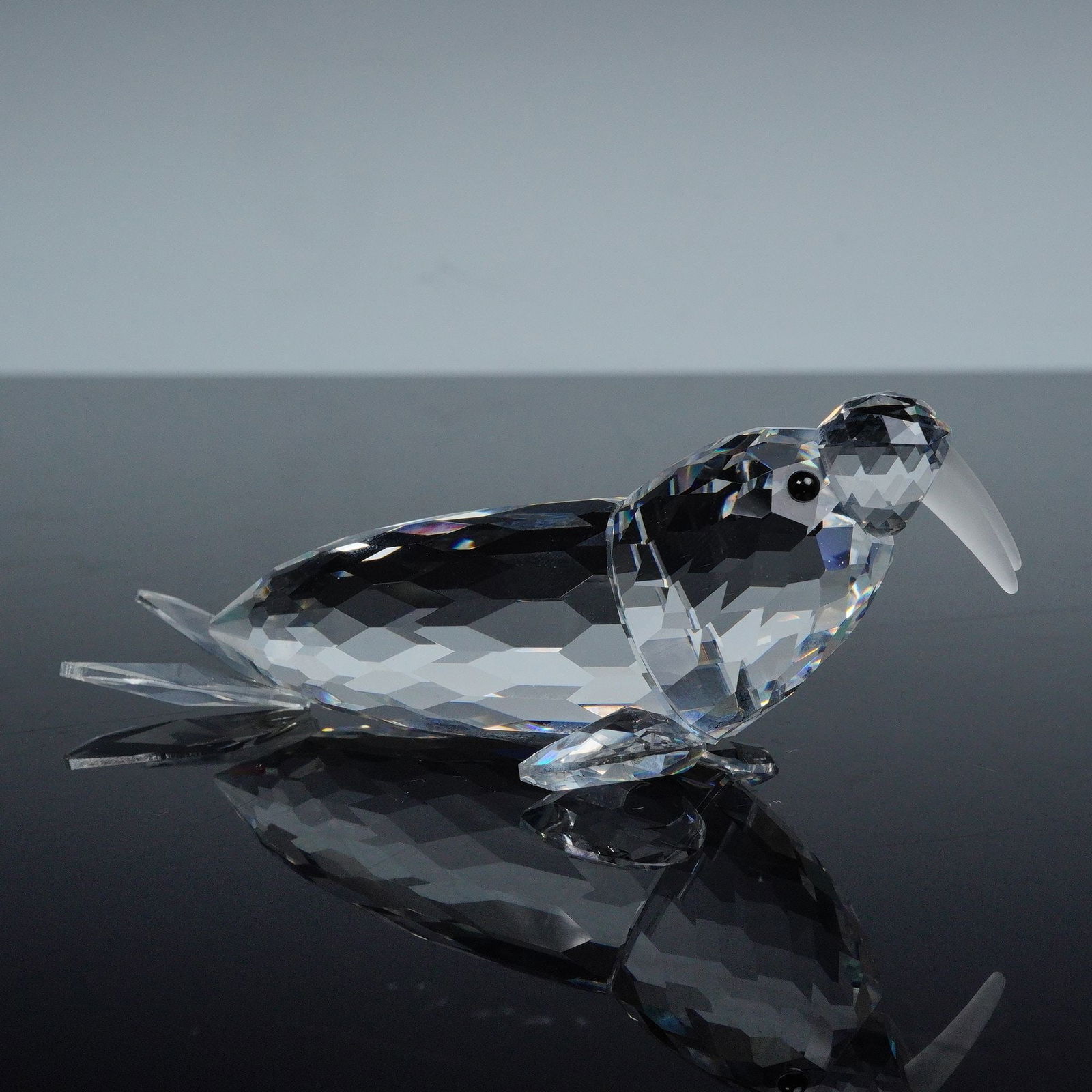 Swarovski Silver Crystal Figurine, Walrus: Faceted clear crystal representation of a walrus in repose, and was part of the Kingdom of Ice and Snow group. The walrus is made from clear crystal, with black eyes and frosted tusks. Swarovski backs