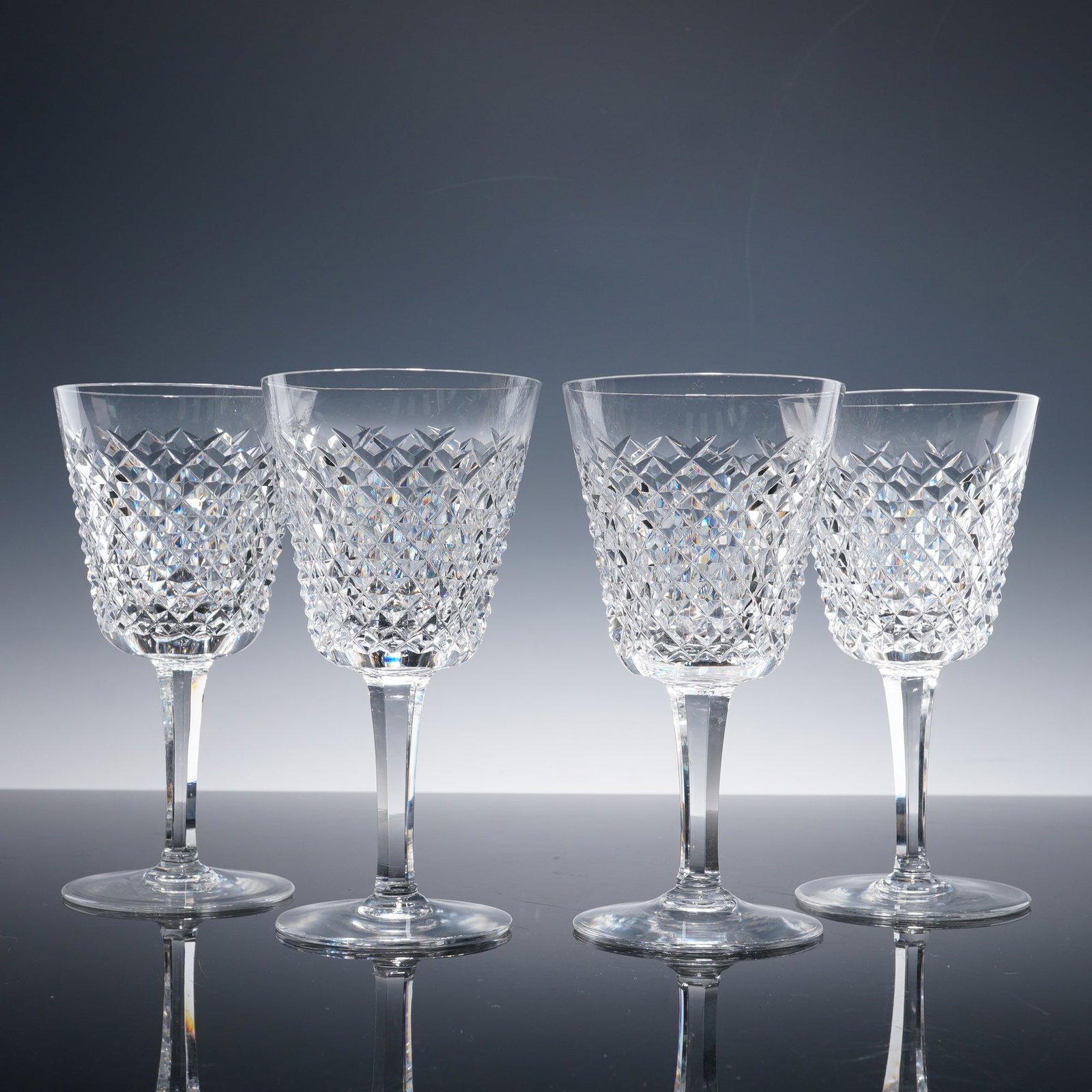 4pc Waterford Crystal Wine Glasses, Alana Pattern: This set of four wine glasses is crafted from premium Waterford Crystal, featuring the classic diamond pattern from the Alana collection. The intricate cut crystal design catches the light beautifully