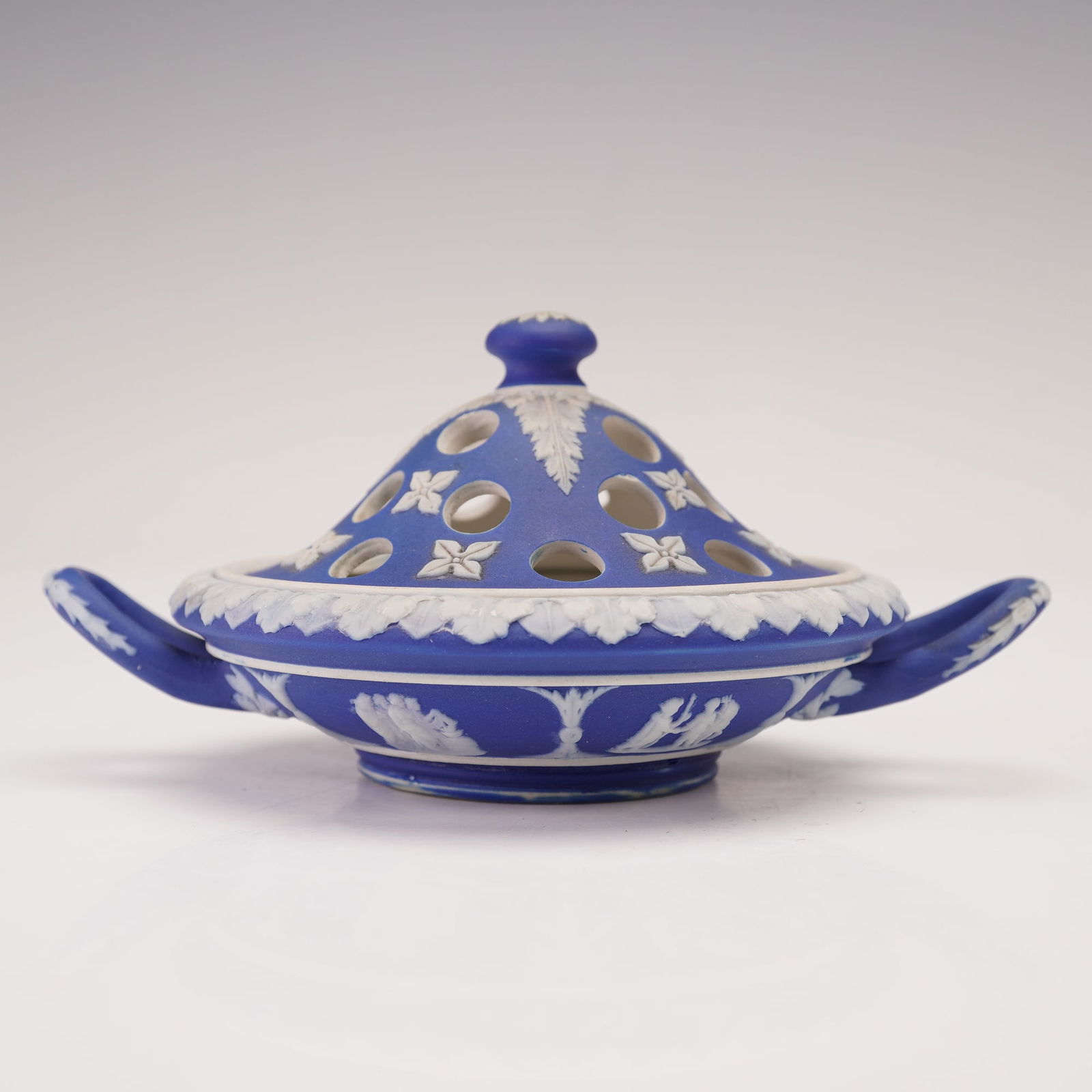 2pc Wedgwood Dipped Blue Jasperware Lidded Potpourri Bowl: Elegant Wedgwood dipped blue jasperware potpourri with white classical relief decoration, featuring foliate and floral motifs. The pierced domed lid allows fragrance to escape, and the twin-handled ba