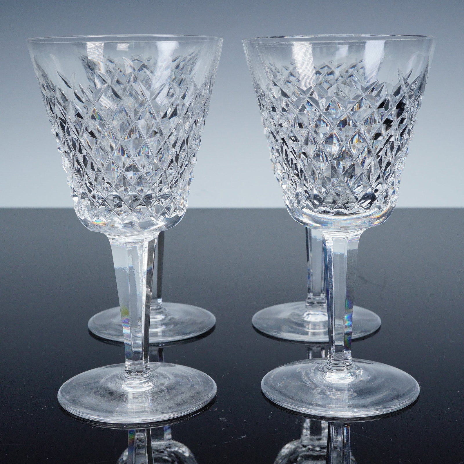 4pc Waterford Crystal Claret Wine Glasses, Alana Pattern: This set of four claret wine glasses is crafted from premium Waterford Crystal, featuring the iconic diamond pattern from the Alana collection. The intricate cut crystal design adds a sparkling touch