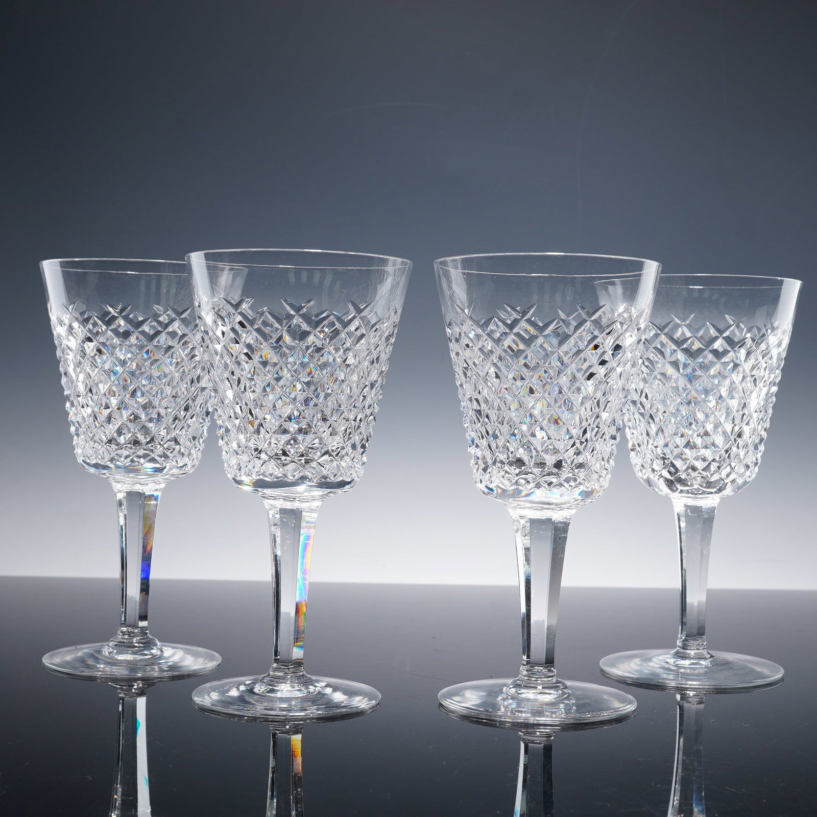 4pc Waterford Crystal Wine Glasses, Alana Pattern: This set of four wine glasses is crafted from premium Waterford Crystal, featuring the classic diamond pattern from the Alana collection. The intricate cut crystal design catches the light beautifully