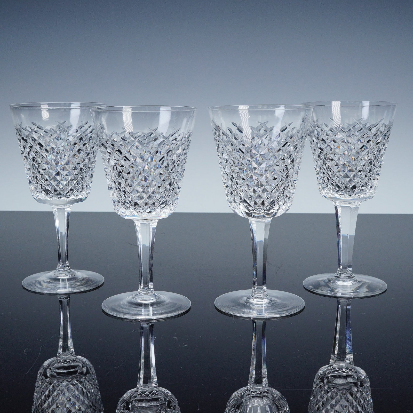 4pc Waterford Crystal Wine Glasses, Alana Pattern: This set of four wine glasses is crafted from premium Waterford Crystal, featuring the classic diamond pattern from the Alana collection. The intricate cut crystal design catches the light beautifully