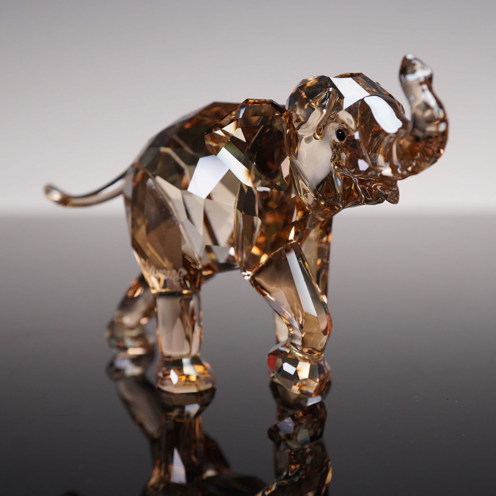 Swarovski Crystal Figurine, 2013 AE Companion Young Elephant, Signed: Charming Swarovski Crystal Society (SCS) 2013 Annual Edition Companion figurine titled "Young Elephant." Designed by Elisabeth Adamer, this beautifully crafted piece depicts a young elephant walking f