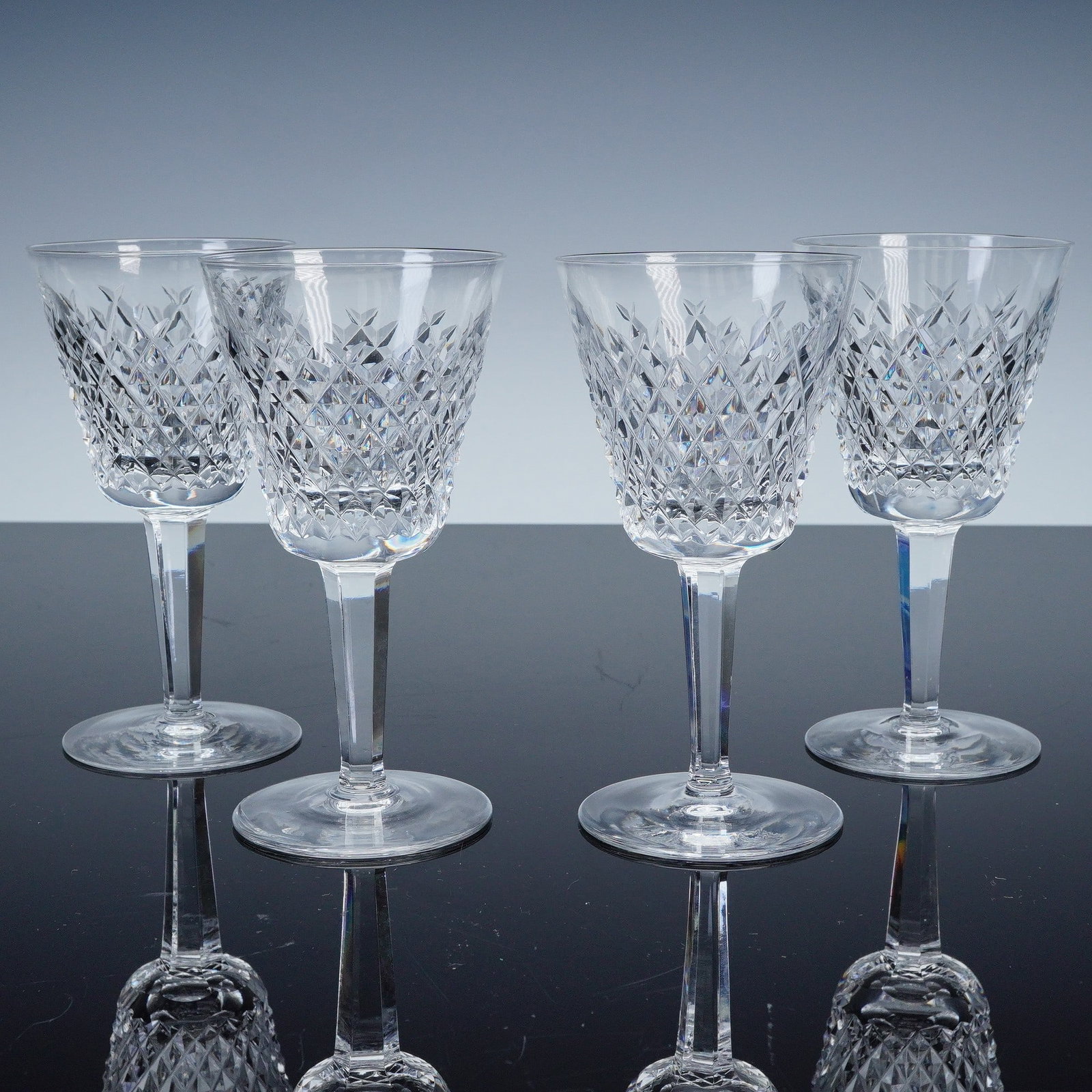 4pc Waterford Crystal Claret Wine Glasses, Alana Pattern: This set of four claret wine glasses is crafted from premium Waterford Crystal, featuring the iconic diamond pattern from the Alana collection. The intricate cut crystal design adds a sparkling touch
