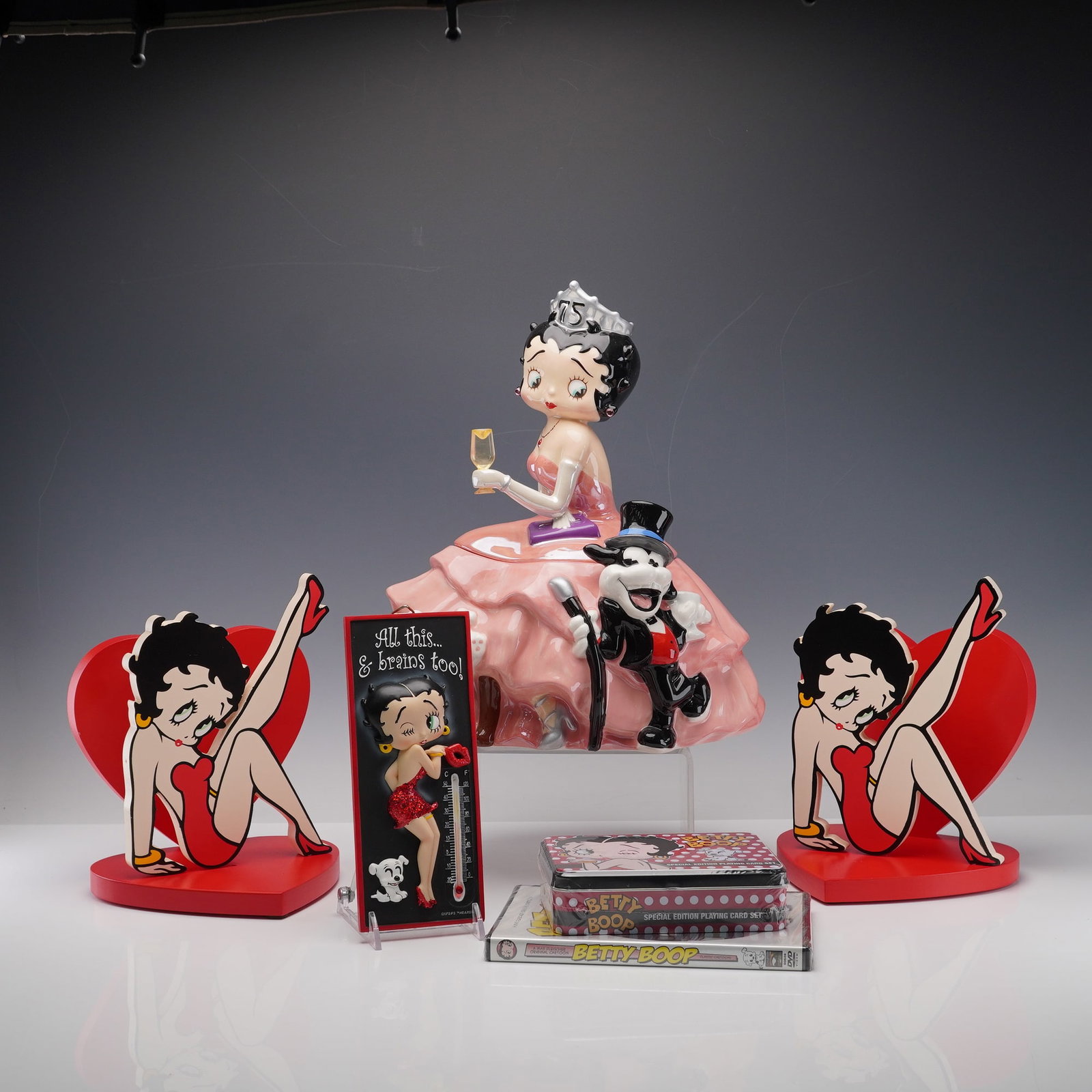 5pc Westland Giftware Betty Boop Collectibles: This charming assortment includes a pair of matching red and heart-shaped Betty Boop bookends featuring the iconic flapper in her signature red dress and heels, a "All This and Brains Too!" thermomete