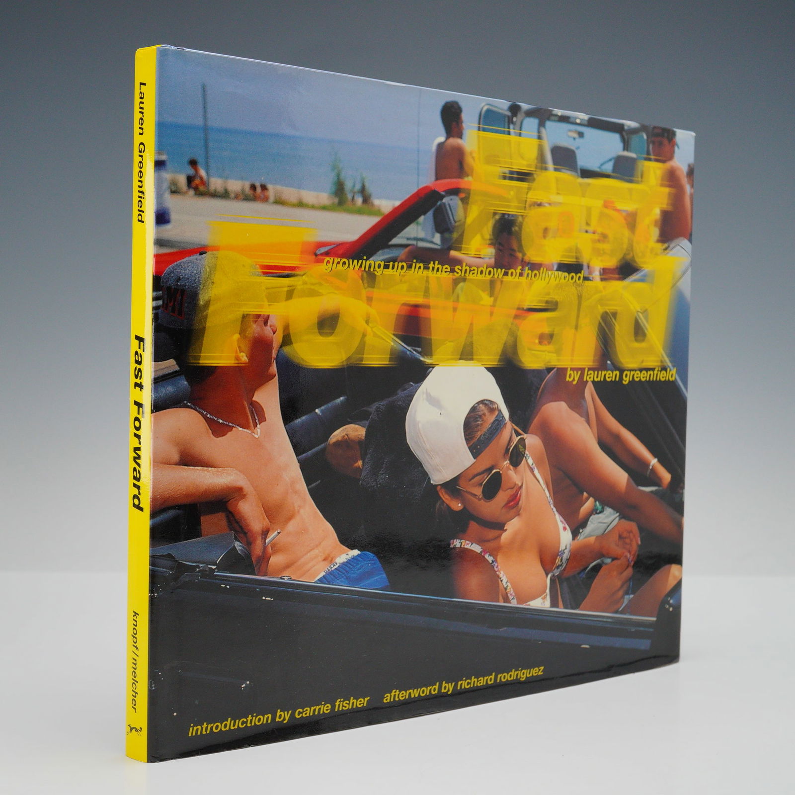 Lauren Greenfield Hardcover Book, Fast Forward: Growing Up in the Shadow of: A striking first edition of Fast Forward, Lauren Greenfield's acclaimed photographic study capturing the youth culture of 1990s Los Angeles. This vibrant and often sobering collection documents the ea