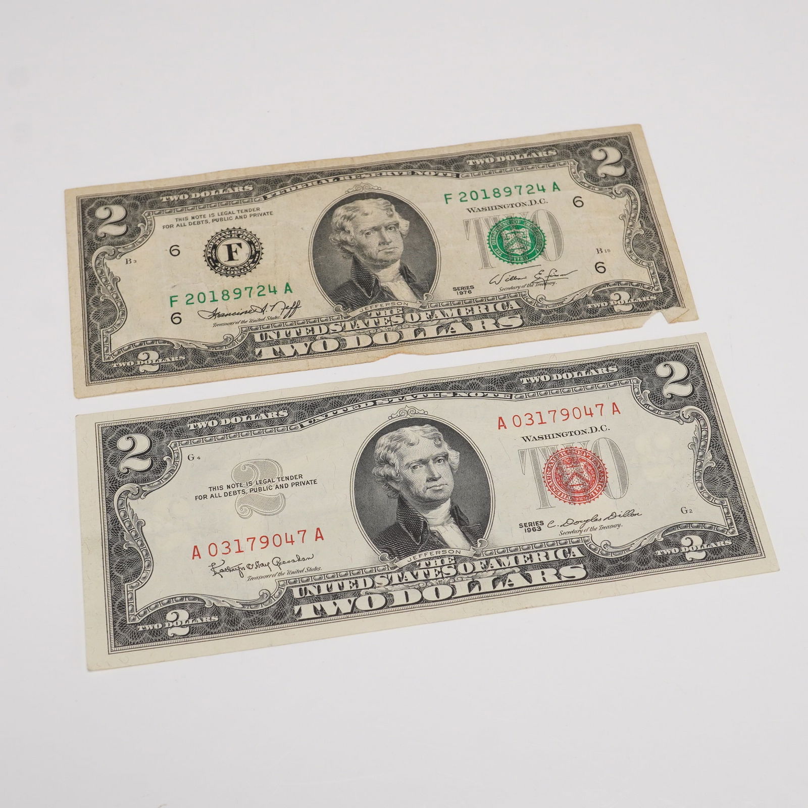 3pc 1953B, 1963, 1976 Series U.S. Two Dollar Bills: A group of three United States $2 bills featuring the portrait of Thomas Jefferson. Includes one 1953B Legal Tender Note and one 1963 Legal Tender Note, both with red Treasury seals and serial numbers