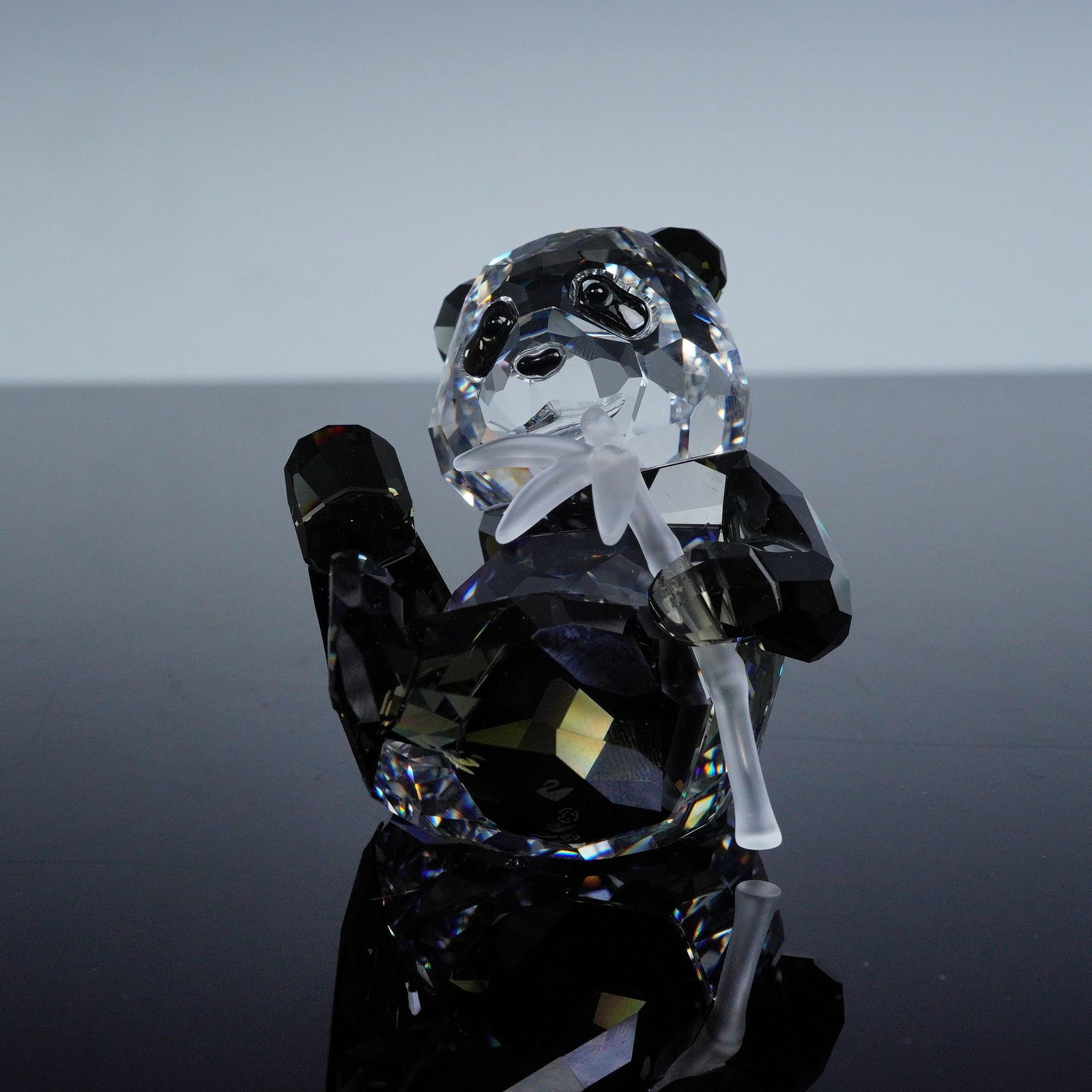 Swarovski Crystal Figurine, Panda Cub: Swarovski 2008 Annual Edition Companion Panda Cub 905543 figurine crafted in clear and black crystal depicting a cute panda chewing on bamboo, bearing the Swarovski backstamp, includes original SCS bo