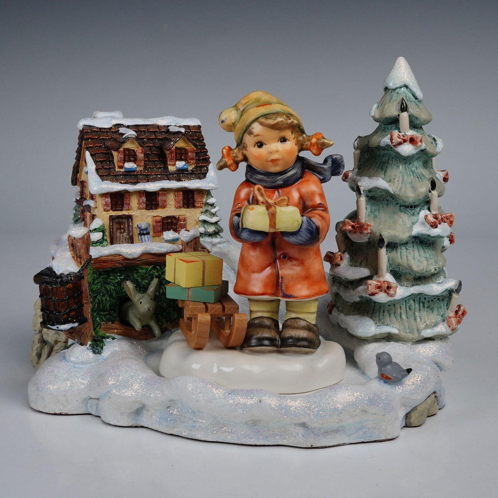 2pc Goebel Hummel Lighted Musical Scene with Figurine, Good Tidings of Joy: A charming two-piece Goebel Hummel Christmas display featuring the 2003 Tidings of Joy lighted musical scene, Mark 1083-D, along with the Exclusive Edition figurine, Good Tidings. The hand-painted por