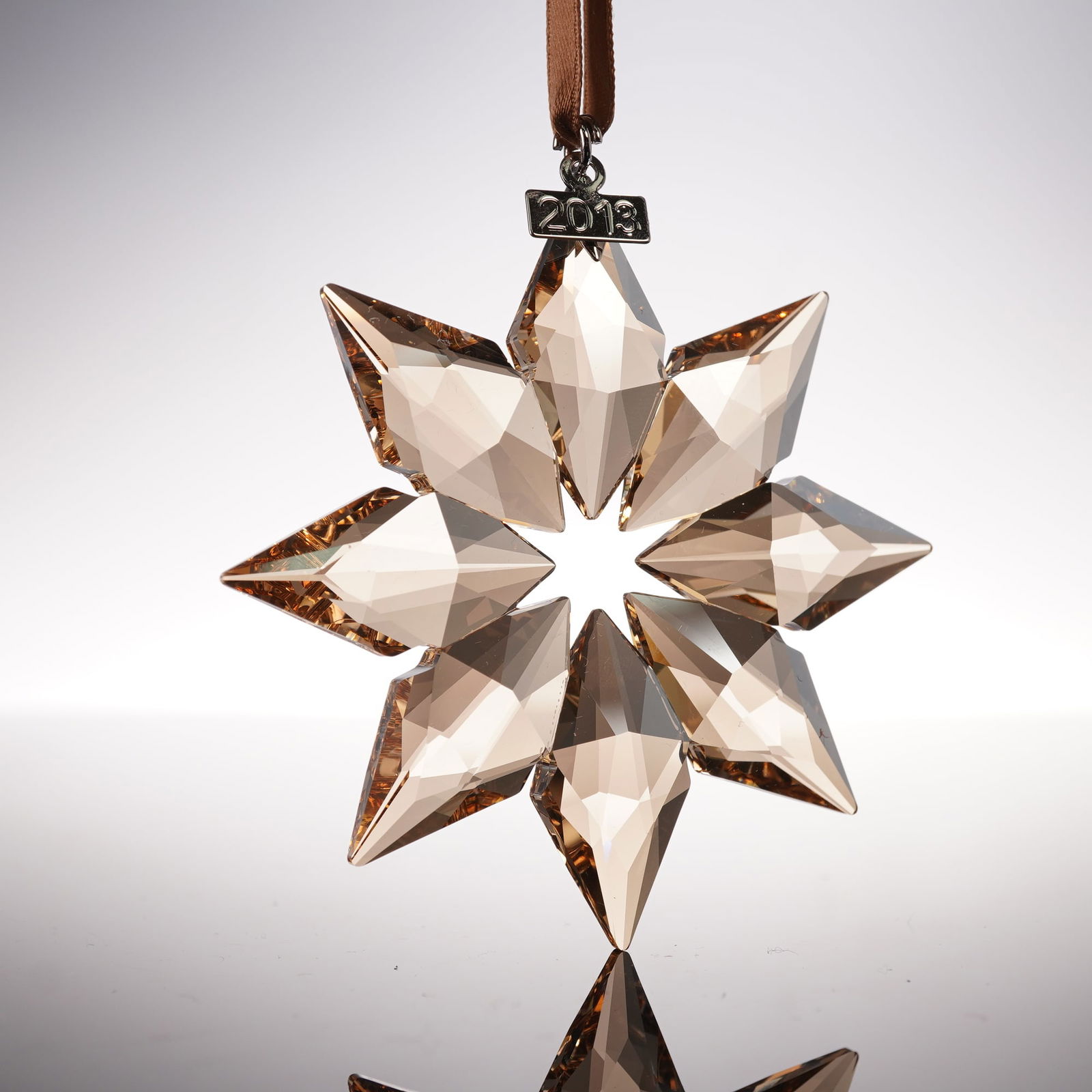 Swarovski Crystal Ornament, 2013 Christmas Gold: Swarovski 2013 Christmas Ornament Gold SCS 5004491 crafted in faceted golden crystal with eight point star design and hanging ribbon, features Swarovski backstamp, includes original box 5.5"H. Artist: