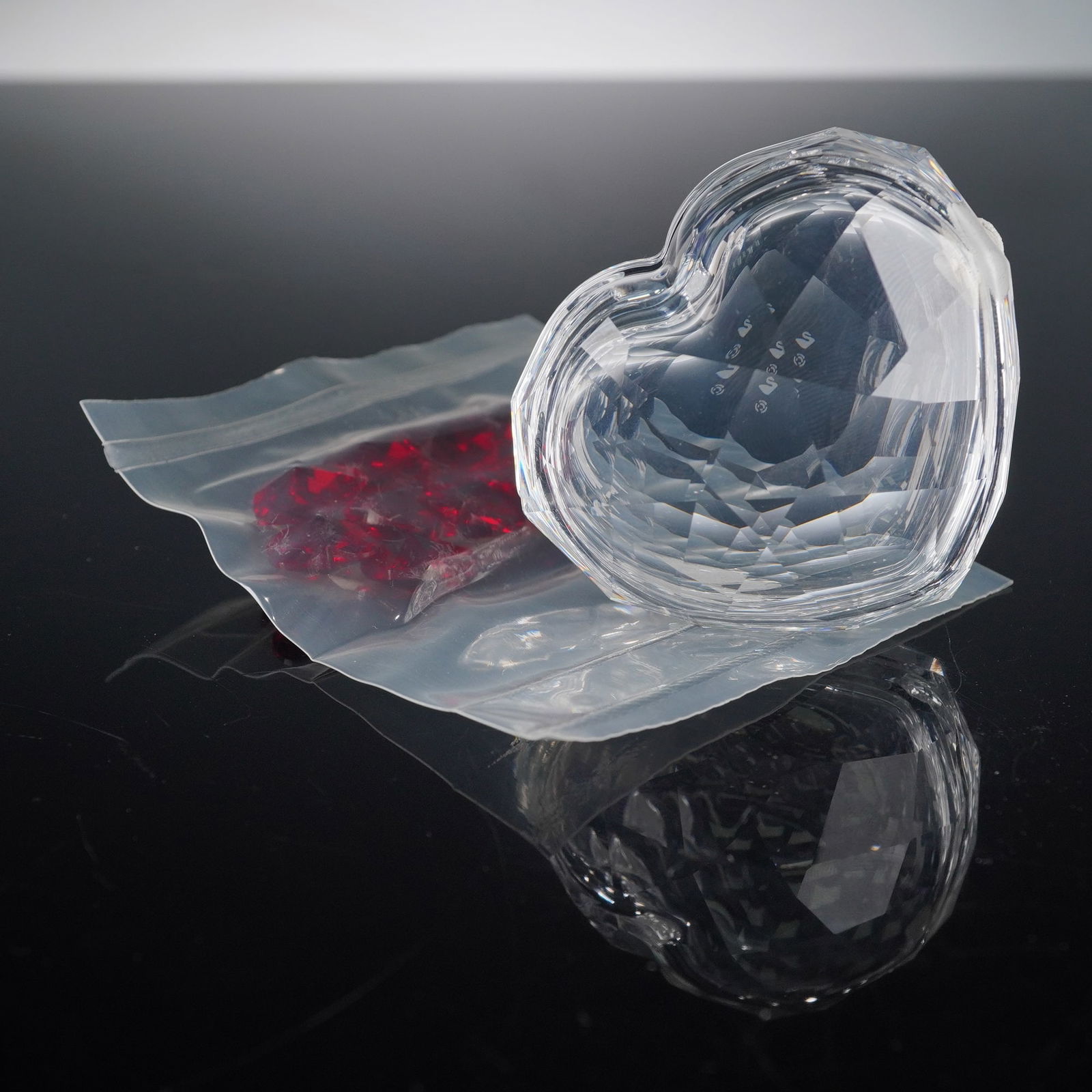 Swarovski Crystal Jewel Heart Box with Red Crystal Hearts: Romantic Swarovski Crystal Jewel Heart Box, designed by Edith Mair for the Crystal Moments collection. This beautifully faceted clear crystal heart box opens to reveal an interior compartment perfect