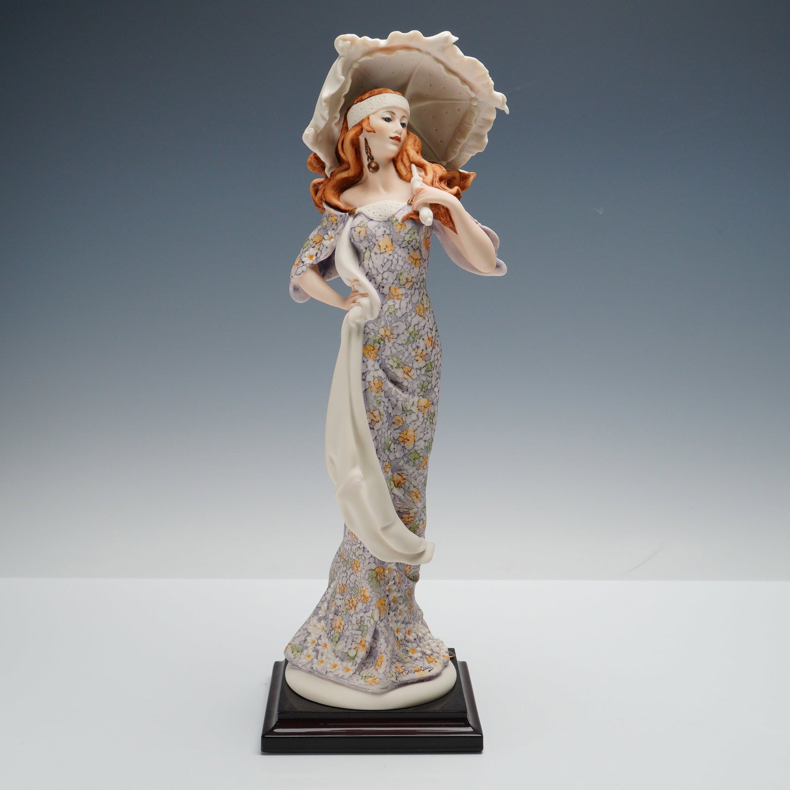 Florence Sculture d'Arte, Lady With Umbrella: Handcrafted in, this elegant porcelain sculpture depicts a fashionable woman in a long floral dress holding a parasol. The piece is mounted on a wooden base with a Florence emblem plaque and features 