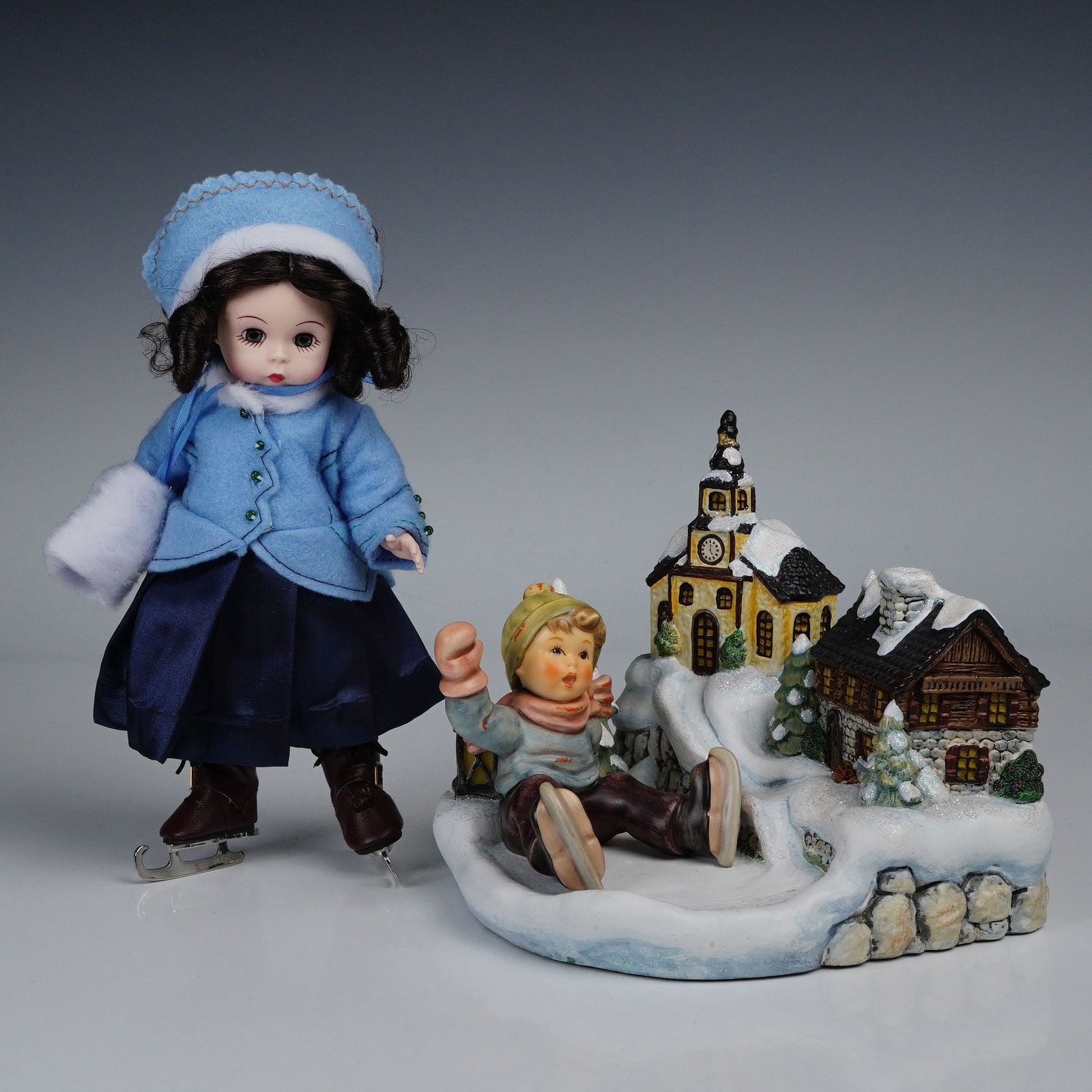 3pc Winter Figurines, Including Goebel Home for the Holidays: Three-piece winter holiday decorations including Goebel Home for the Holidays dated 2002, featuring a snowy village display. Additionally featured is a Goebel seated figure and a coordinating winter d