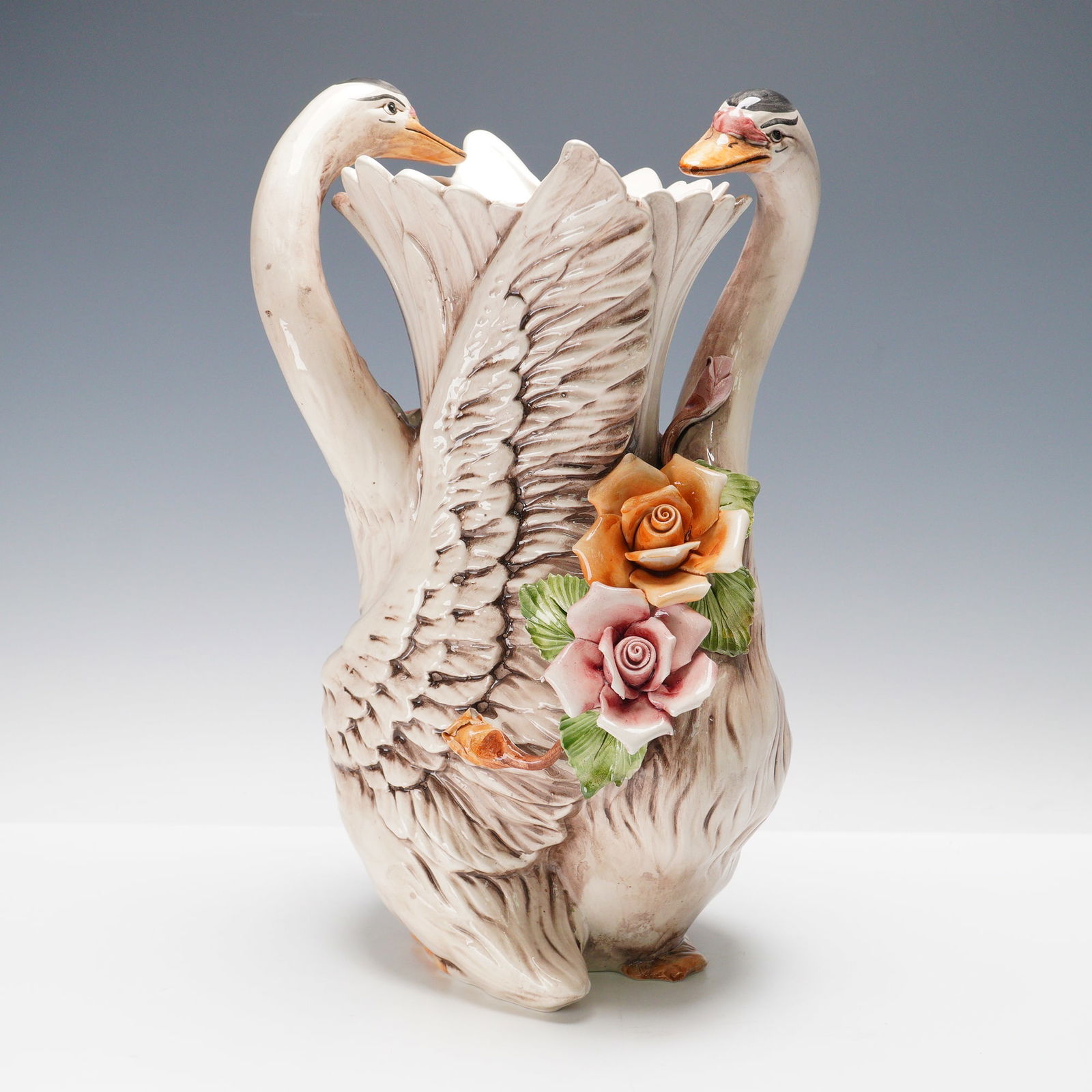 Capodimonte Italian Porcelain Swan & Floral Vase: An impressive hand-painted Capodimonte porcelain vase crafted in Italy, depicting a pair of graceful swans forming the body of the vessel. Standing approximately 15 inches tall, this striking piece ex