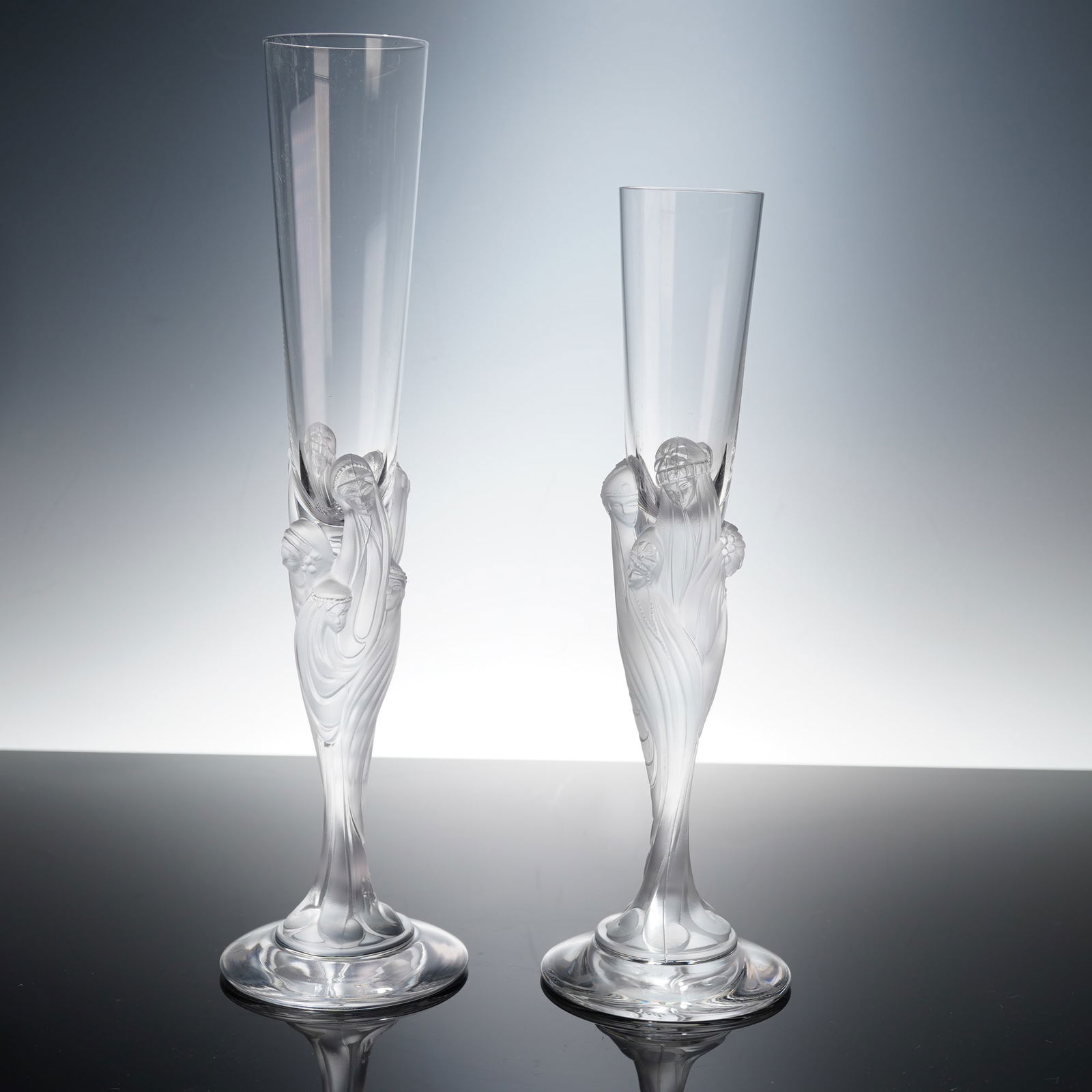 2pc Erte Crystal Champagne Glasses, Majestique: Limited edition crystal champagne flutes designed by Erte (Romain de Tirtoff) for French production. Each glass features frosted and clear crystal decoration depicting elegant Art Deco female figures