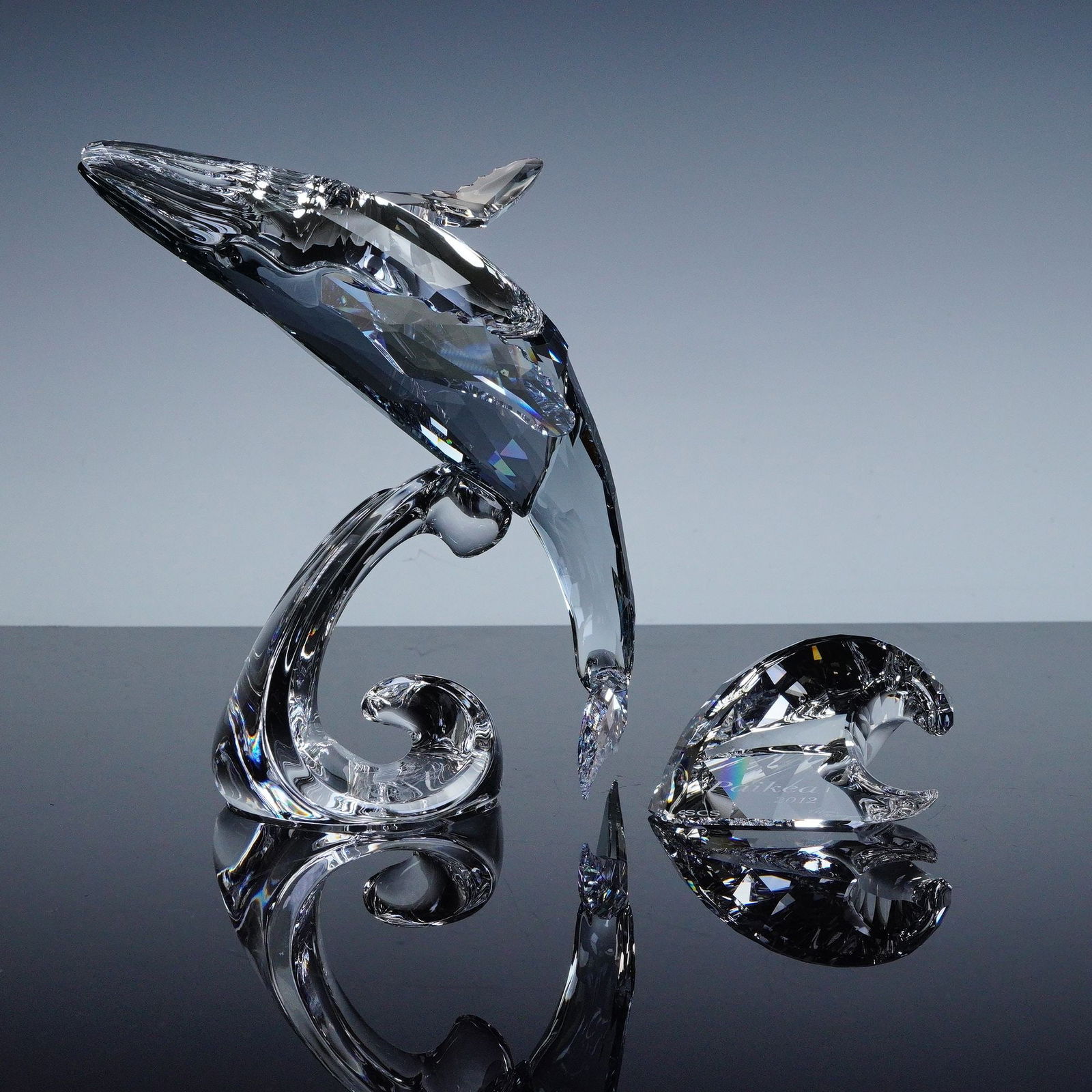 Swarovski Crystal 2012 AE Paikea Humpback Whale Figurine + Plaque, Signed: The Swarovski Crystal Society 2012 Annual Edition Paikea Humpback Whale, designed by Viktar Korol, captures the majesty of the ocean's most graceful giant. The clear crystal whale rises above a cresti