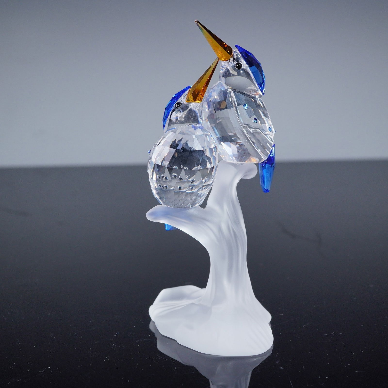 Swarovski Malachite Kingfishers: A Swarovski 'Malachite Kingfishers' figurine, model number 623323, featuring two stylized birds perched on an integral frosted crystal branch. The birds' bodies are crafted from multifaceted clear cry