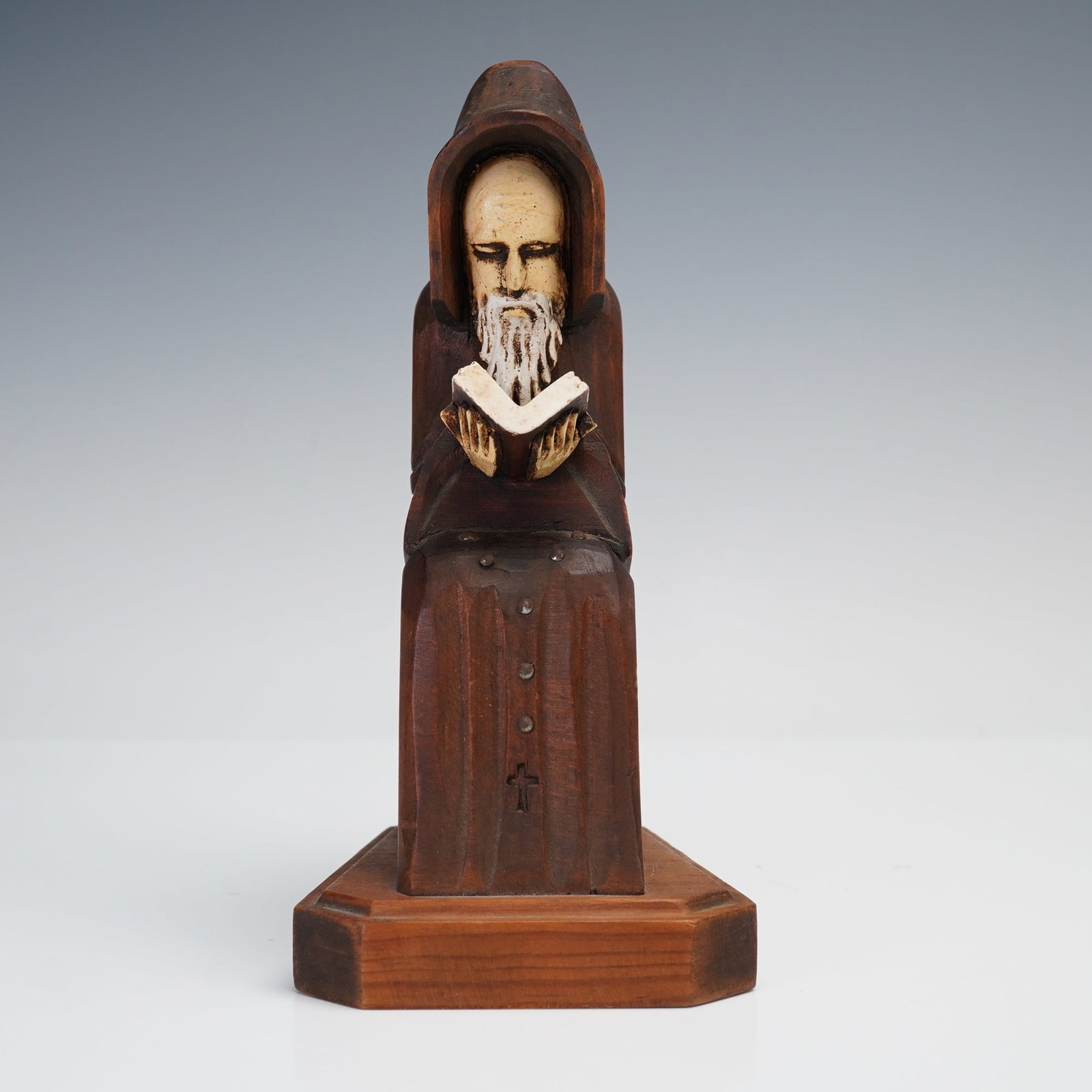 Mexican Hand Carved Monk Bookend: Wooden monk bookend depicting a hooded figure deeply engrossed in reading. The serene composition features a long-bearded monk seated with an open book, carved from a single block of wood and mounted 