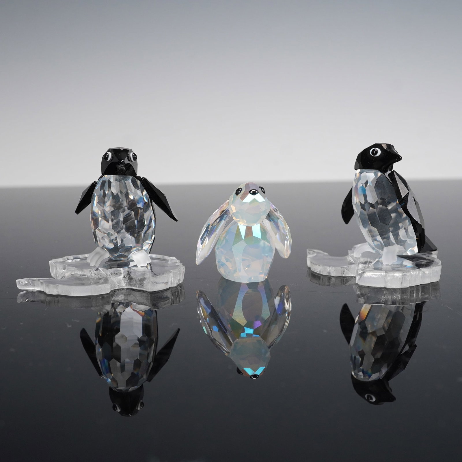 3pc Swarovski Crystal Penguins and Rabbit Figurines: A trio of crystal figurines comprising two silver crystal penguins, Sir Penguin 191448 and Madame Penguin 206977. Also included is Lovlots Circus Benny The Bunny Rabbit 1072348. Benny is the magician