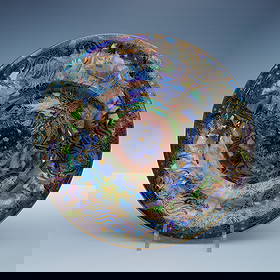 Wedgwood Fairyland Lustre Jumping Faun Bowl: A stunning Wedgwood Fairyland Lustre "Jumping Faun" bowl, measuring 1.75" in height and 9.5" in diameter. This intricately decorated bowl features vibrant iridescent colors and gilded highlights, show