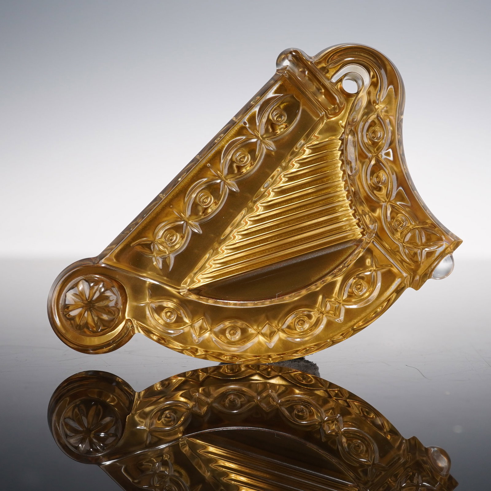 Waterford Crystal Harp Ornament with Gold Accents: This stunning Waterford crystal harp tree ornament features intricate detailing with a vibrant gold-tone finish, adding a touch of elegance to the piece. The ornament is marked with the iconic Waterfo