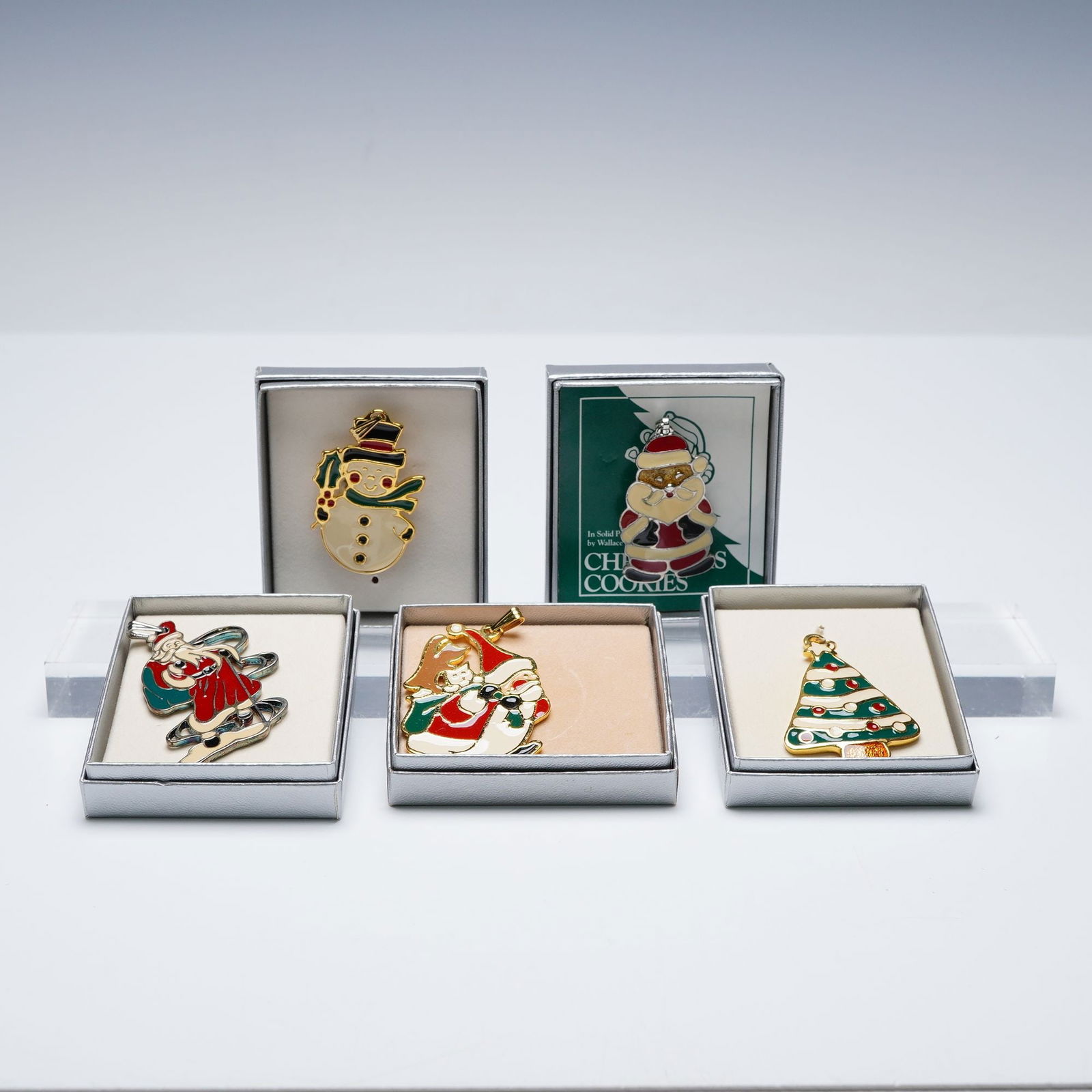 5pc Wallace Silversmiths Enameled Christmas Pendants: A festive collection of five silver toned and gold toned ornaments, each elegantly crafted with hand-painted enamel in holiday hues of red, green, white, and gold. This grouping features a Christmas T
