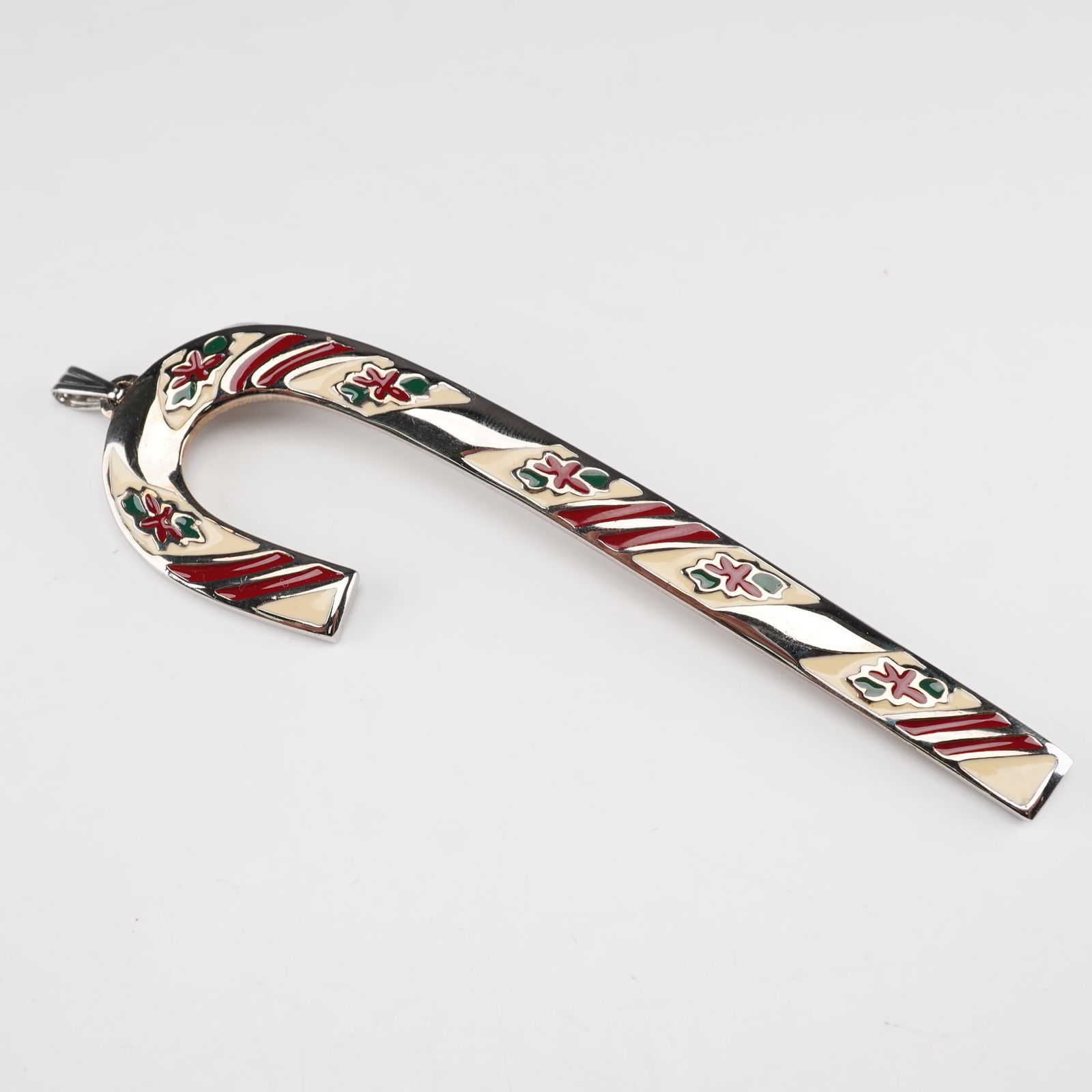 Wallace Silversmith Peppermint Candy Cane Ornament: Celebrate the holiday season with this beautiful 1981 Wallace Silversmiths Peppermint Candy Cane Ornament, the first in Wallace's beloved annual series. Expertly crafted in solid pewter, this festive