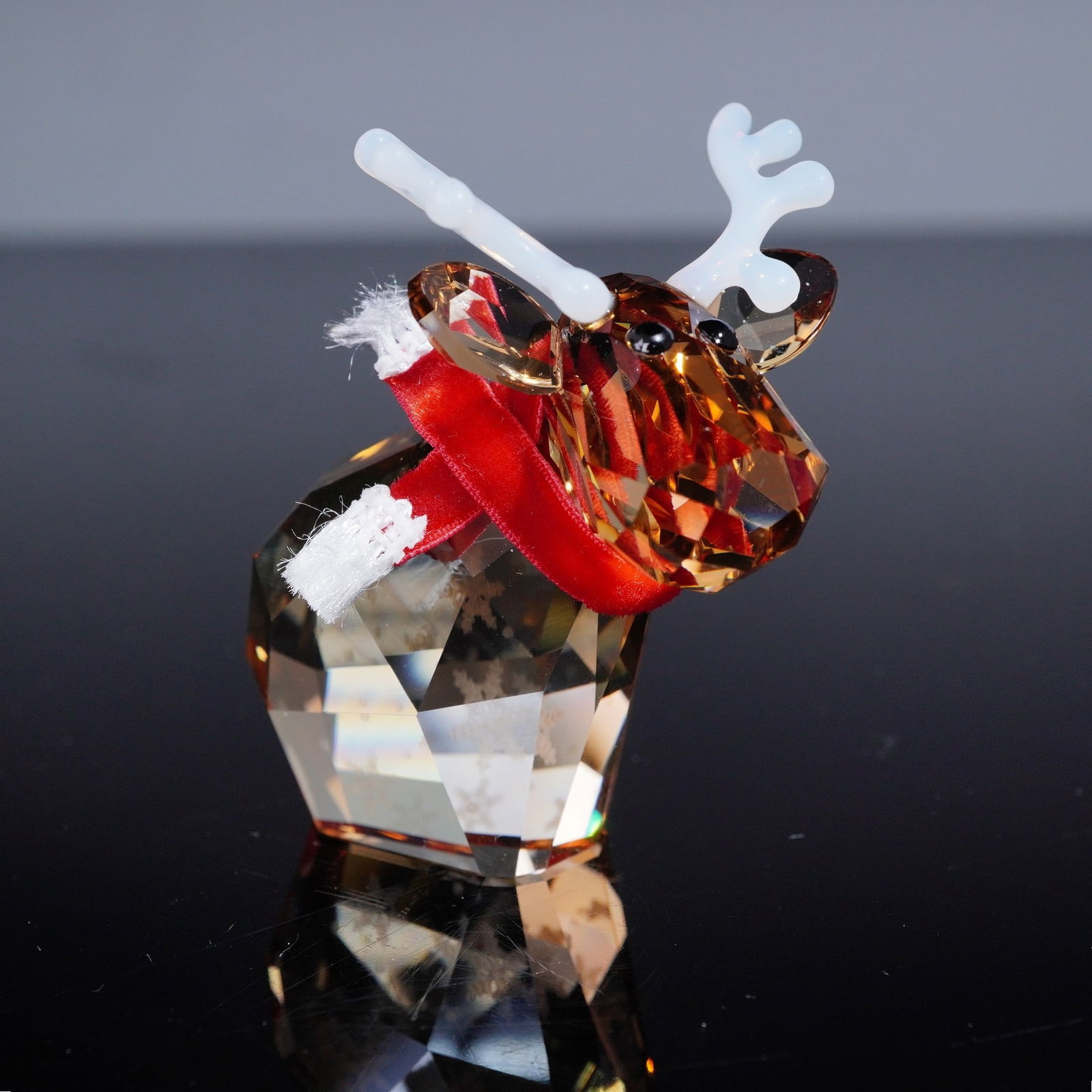 Swarovski Crystal Lovlots Figurine, Reindeer Mo: Swarovski crystal figurine Reindeer Mo, part of the whimsical Lovlots collection, issued in 2014. The playful reindeer is crafted in golden topaz-colored crystal, accented with white crystal antlers a