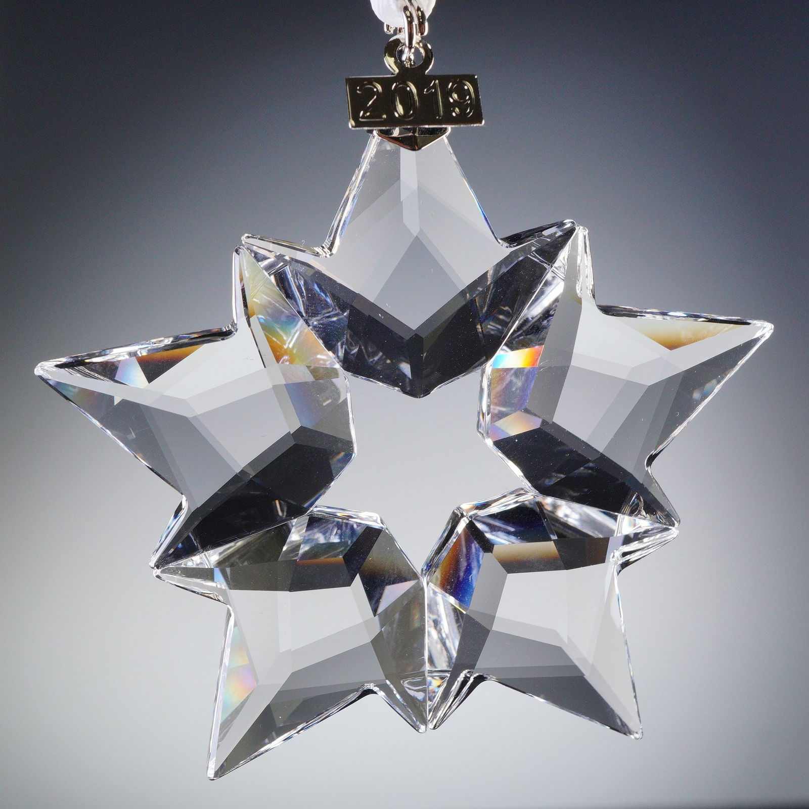 Swarovski Crystal Ornament, Clear Holiday Annual Edition: Celebrate the holiday season with timeless elegance through this Swarovski Annual Edition Ornament from 2019. Expertly crafted from precision-cut clear crystal, this dazzling snowflake-inspired star r