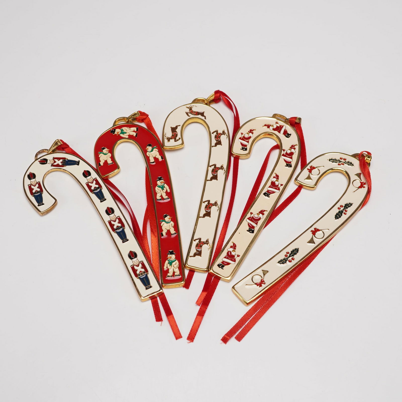 5pc Wallace Silversmiths Annual Candy Cane Ornaments: This delightful five piece set includes Wallace Silversmiths Annual Candy Cane ornaments from 1995 through 1999. Four feature bright white enamel backgrounds and one a deep red finish, each decorated