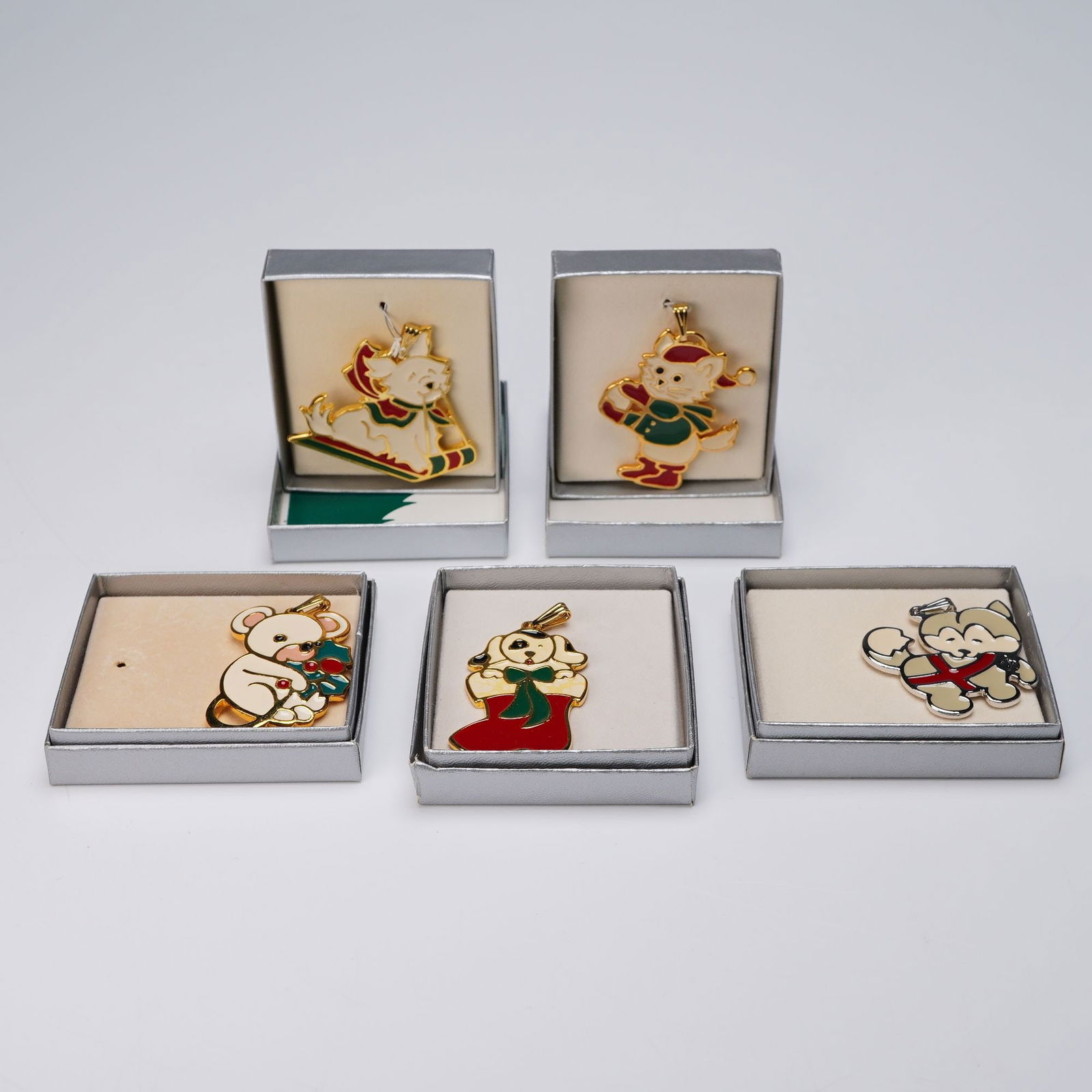5pc Wallace Silversmiths Christmas Cookie Ornaments: Five ornaments featuring designs of a puppy in boot, cat, husky dog, puppy on toboggan, and mouse, with four gold-toned and one silver-toned finish. Each features red, green, and white enamel decorati
