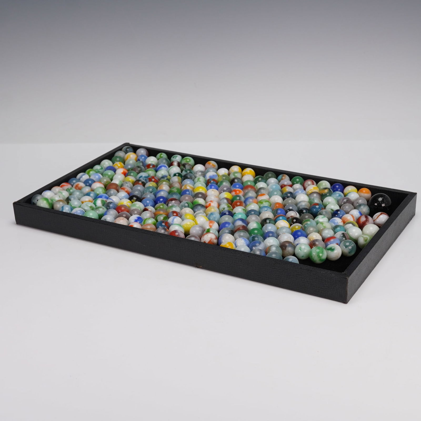 Collection of 150+ Assorted Glass Marbles: A group of 150+ assorted glass marbles in varied colors and swirl patterns. The group includes a mix of opaque and translucent examples, with bright tones of blue, green, red, yellow, and more. Some f
