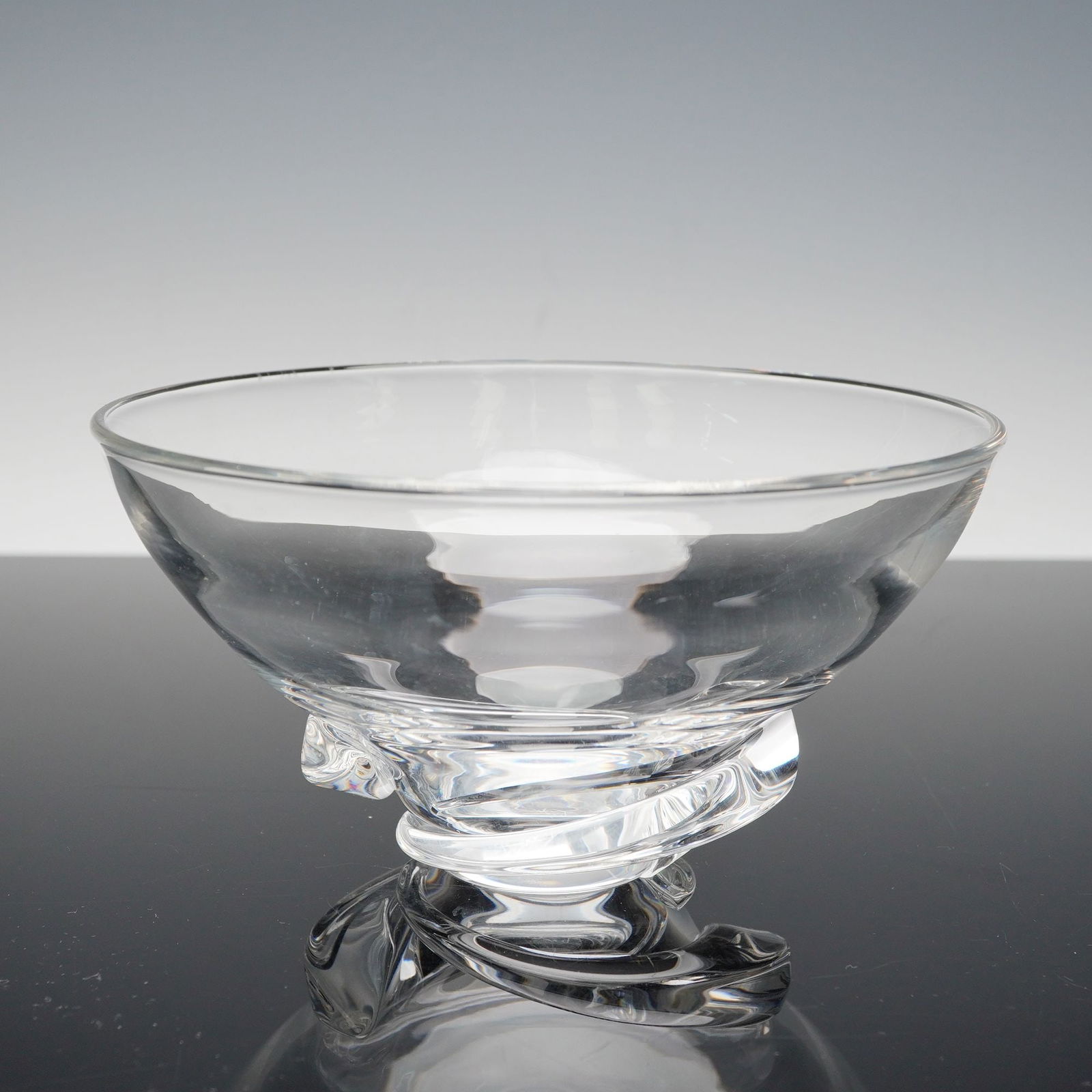 Steuben Clear Crystal Bowl on Swirl Base: Elegant Steuben crystal bowl featuring a sculptural freeform base with fluid, swirling lines characteristic of the brand's master glasswork. The clear crystal exhibits remarkable clarity and brillianc