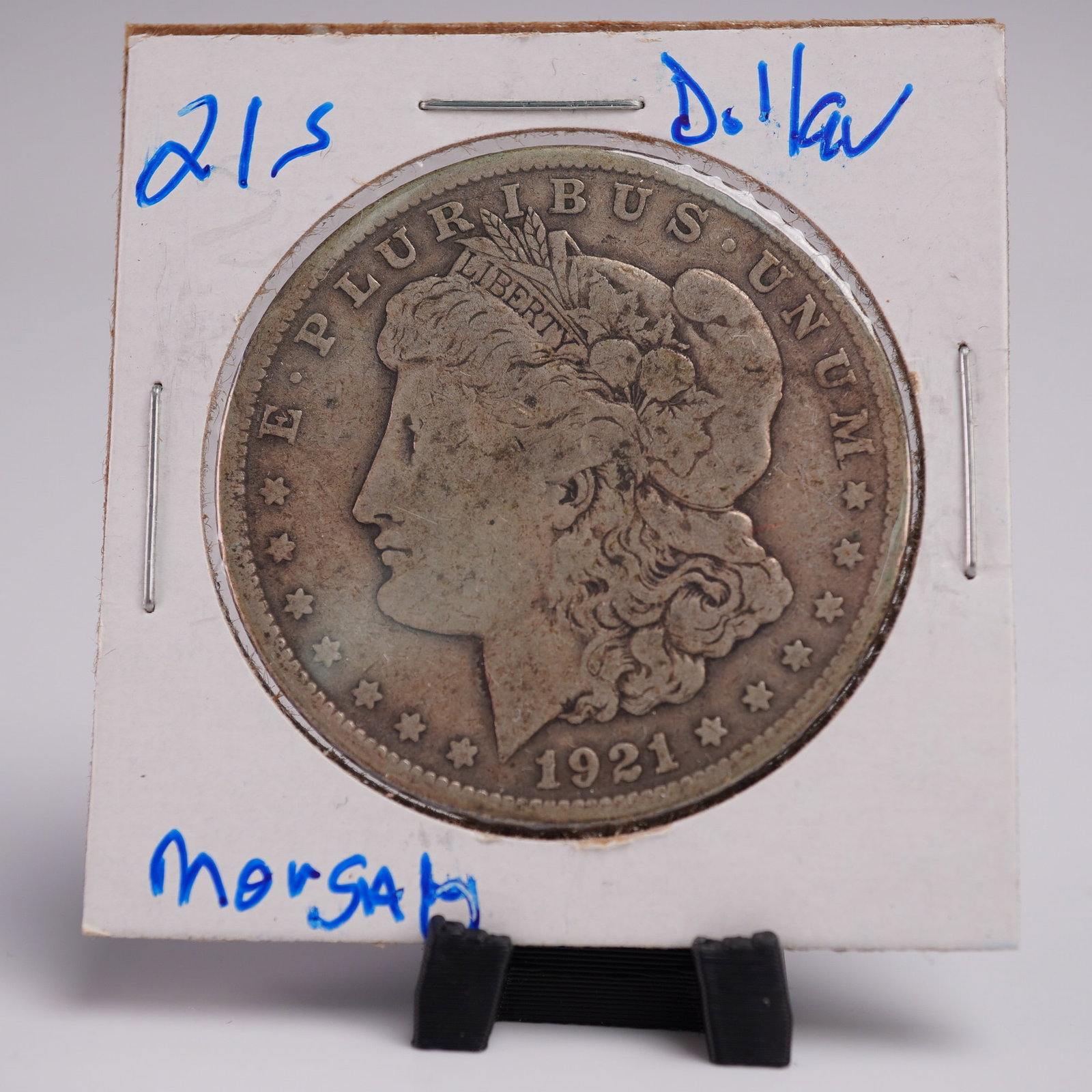 1921-S Morgan Dollar Silver One Dollar Coin: This 1921-S Morgan Silver Dollar, minted in San Francisco and identified by the prominent "S" mintmark, features the time-honored obverse portrait of Liberty facing left, wearing a coronet inscribed L