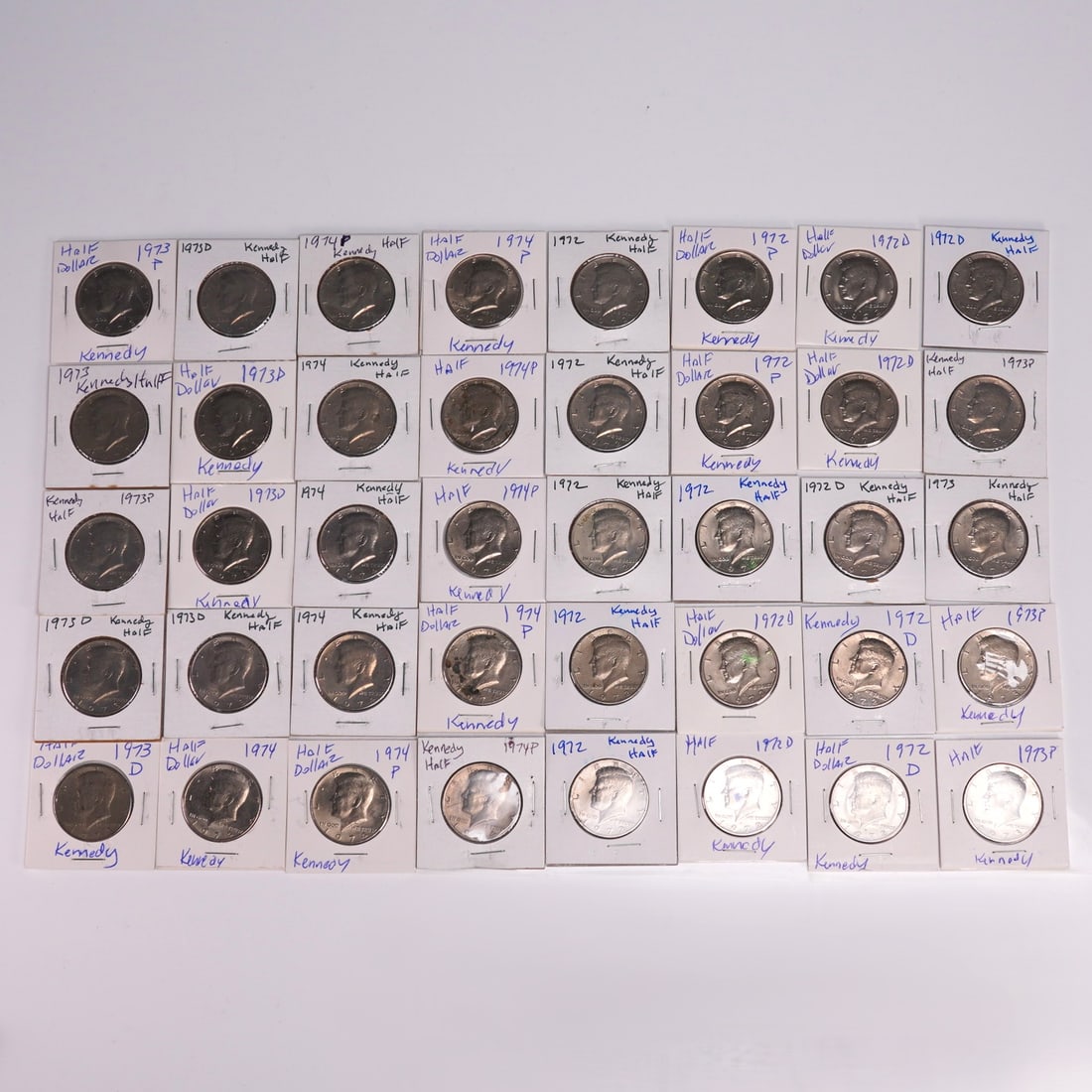 40pc Kennedy Half Dollar Coins 1970s in Holders: Collection of 40 Kennedy half dollar coins dated primarily 1971 to 1974, each featuring the profile of President John F. Kennedy on the obverse and the Presidential Seal on the reverse. These coins we