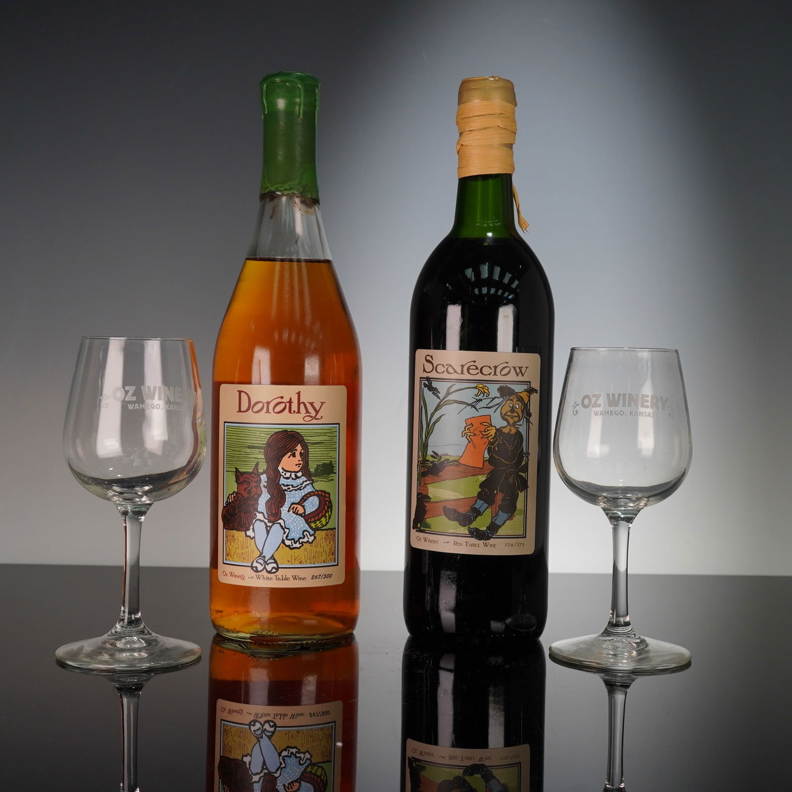 4pc Oz Winery Wines and Glasses, Dorothy and Scarecrow: A charming duo from the Oz Winery of Wamego, Kansas, presented in their original branded wooden display crates. This set includes one bottle of Dorothy, edition number 267 of 500, a sweet white table