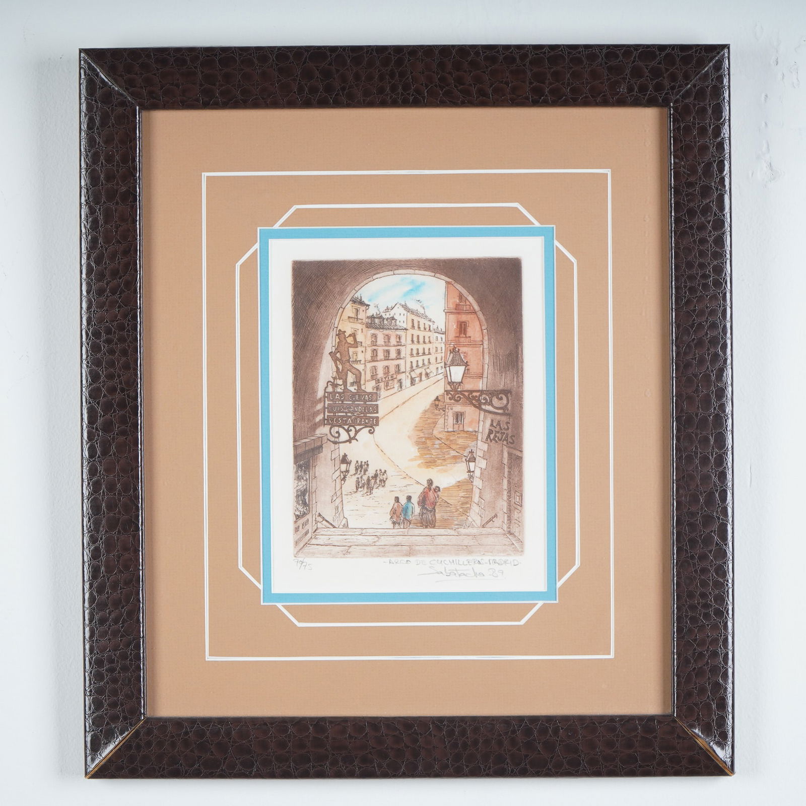 Arco de Cuchilleros Madrid Color Etching Signed by Sabatacha: This is a hand-colored limited edition etching titled Arco de Cuchilleros Madrid by the artist Sabatacha, dated 1989. The scene captures a classic view through the Arco de Cuchilleros, one of the most