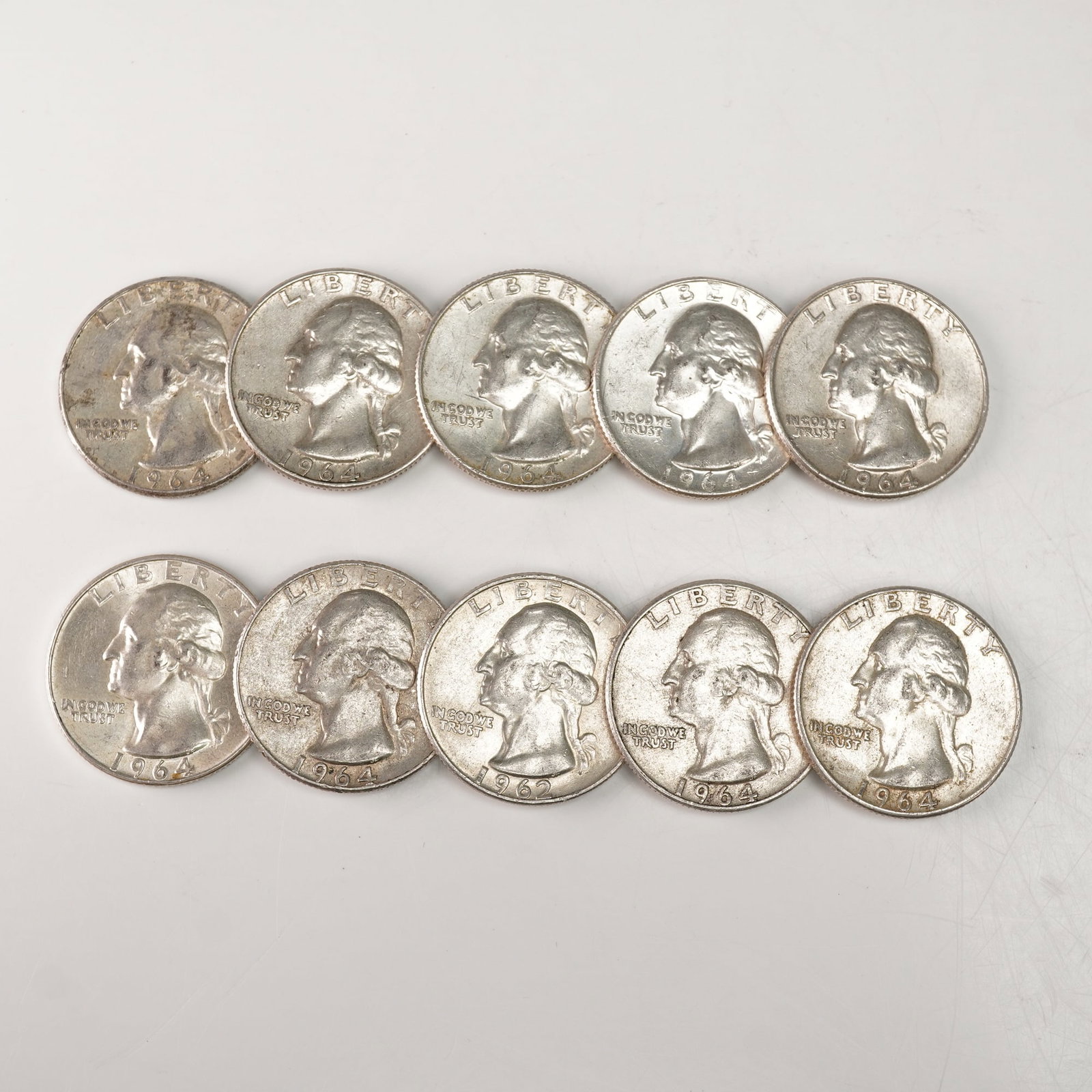 10pc 1962 to 1964-D Washington Silver Quarters: Each coin features the left-facing portrait of George Washington on the obverse, with inscriptions LIBERTY, IN GOD WE TRUST, and the year of issue below. The reverse depicts a heraldic eagle with outs