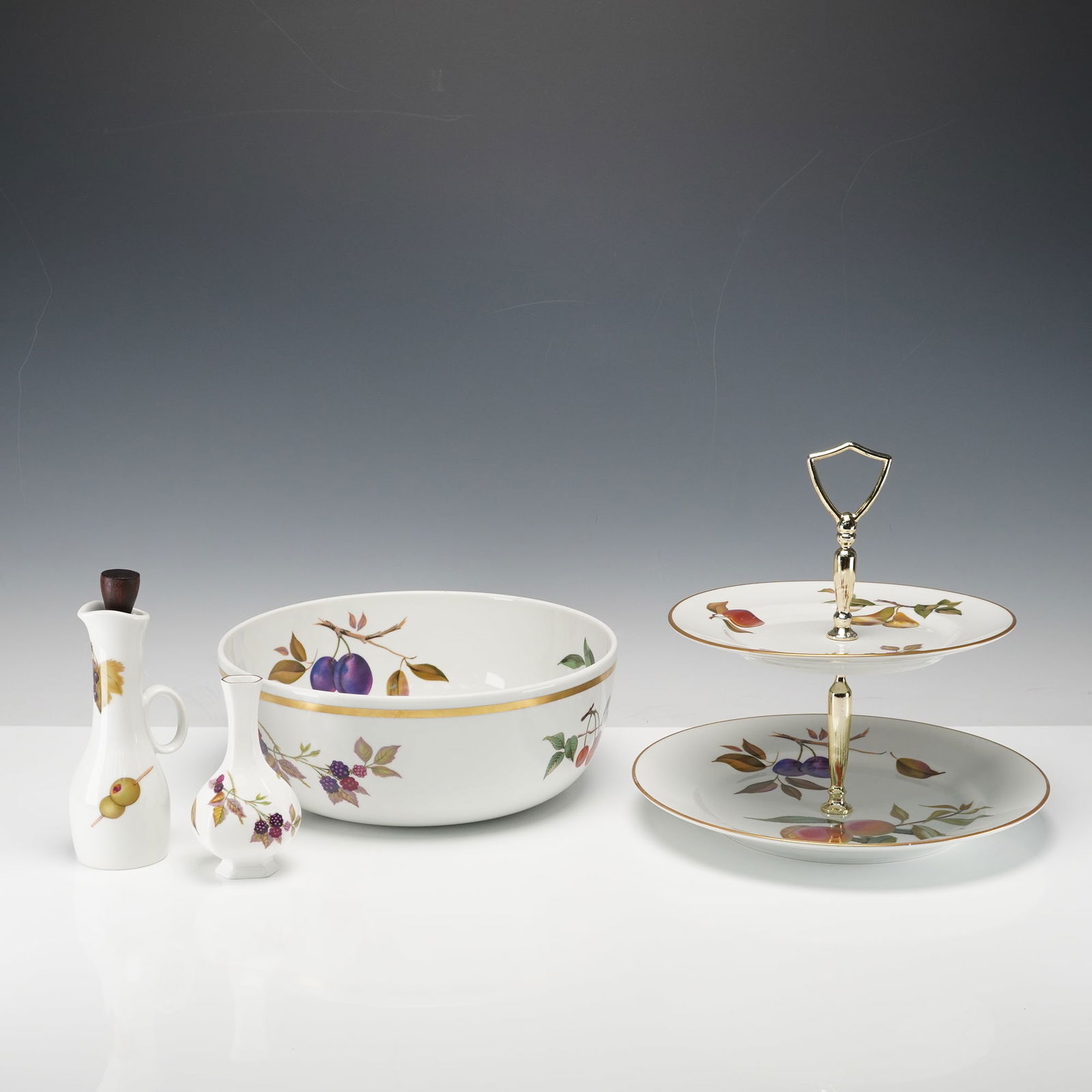 4pc Royal Worcester Porcelain Two Tiered Serving Tray & Bowl, Evesham: Set of four serveware pieces in the classic Evesham pattern. The lot includes a two-tier serving tray, large fruit or salad bowl, cruet pitcher with wooden stopper, and a bud vase. Each piece is decor