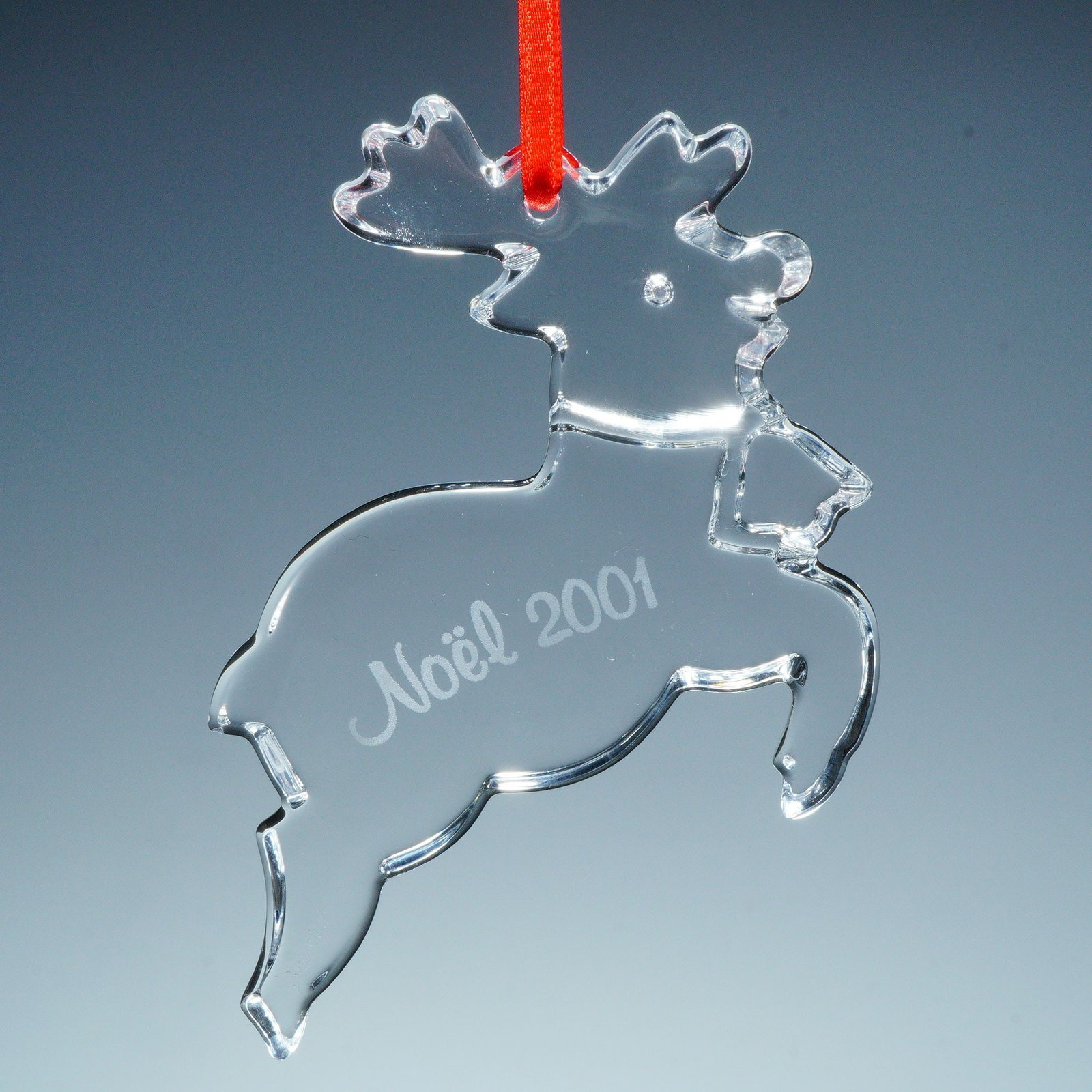 Baccarat Crystal Annual Ornament, Reindeer 2001: This elegant Baccarat crystal ornament was issued for Christmas 2001 and features a beautifully sculpted reindeer rendered in clear, polished crystal. Expertly crafted in France, the design captures t