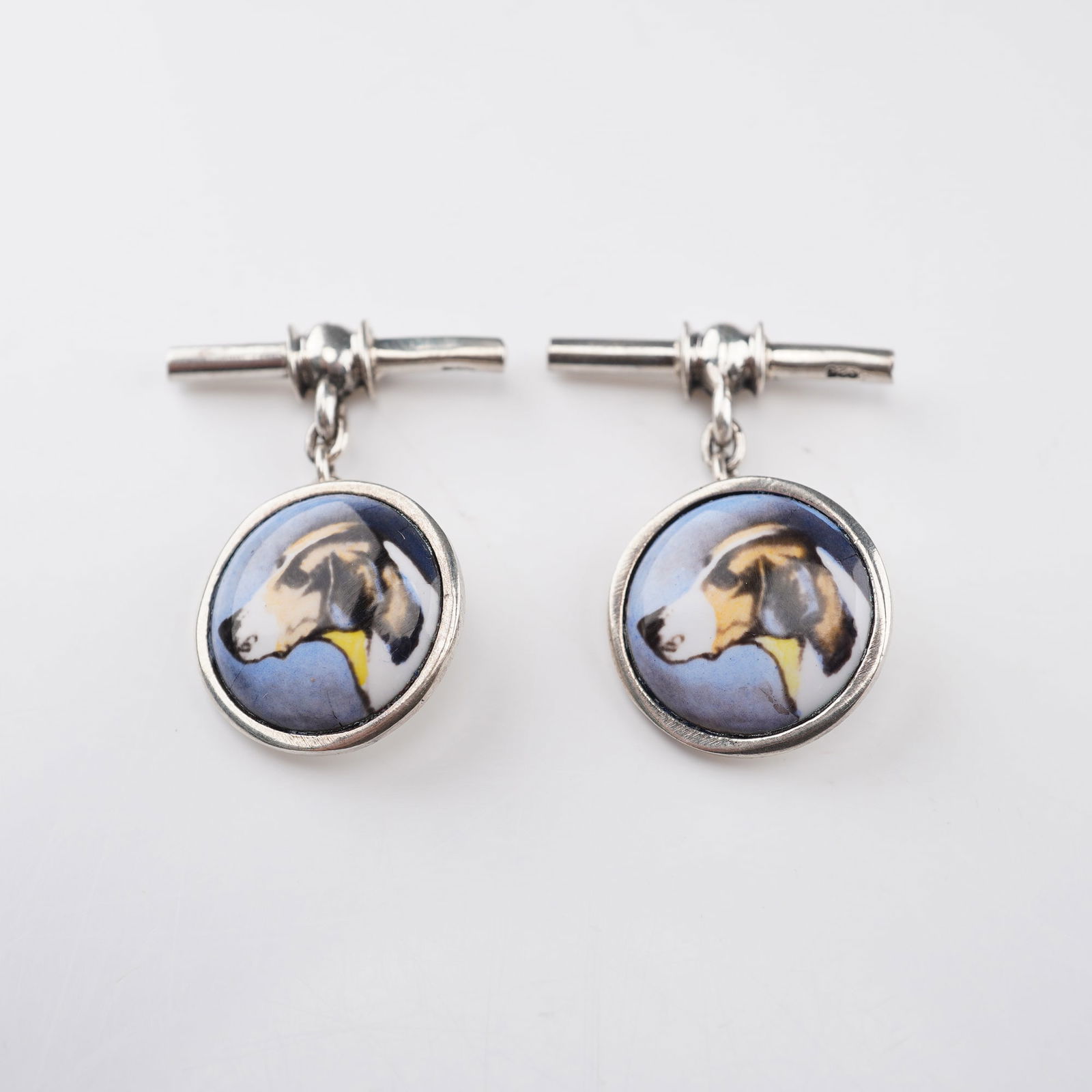 Sterling Silver Hunting Dog Pictorial Cufflinks: This pair of sterling silver cufflinks features a finely detailed pictorial tile, each showcasing a hunting dog in profile. The tiles are set in a 925 silver frame, offering an elegant and collectible