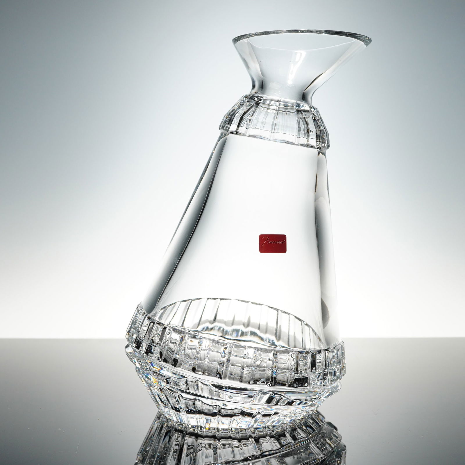 Baccarat Crystal Variations Decanter: Baccarat crystal Variations decanter designed by Patricia Urquiola. Features an elegant modern form with distinctive cut detailing and a flared rim. Etched Baccarat France hallmark and signature to ba