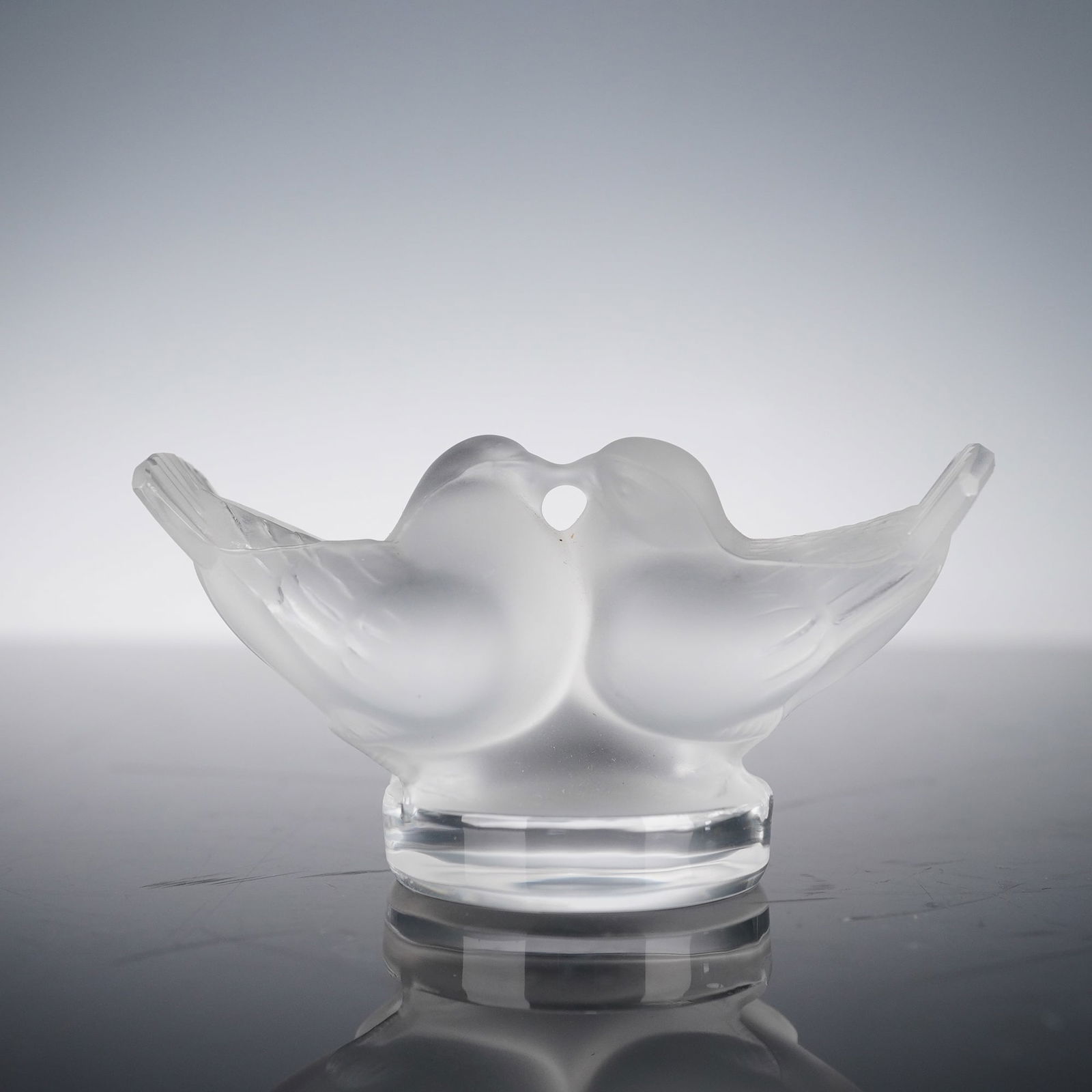 Lalique Crystal Paperweight, Clear Frosted Lovebirds: This exquisite Lalique crystal Lovebirds paperweight is crafted in clear and frosted crystal. The charming design captures two lovebirds gently touching beaks, with their delicate wings and soft, fros