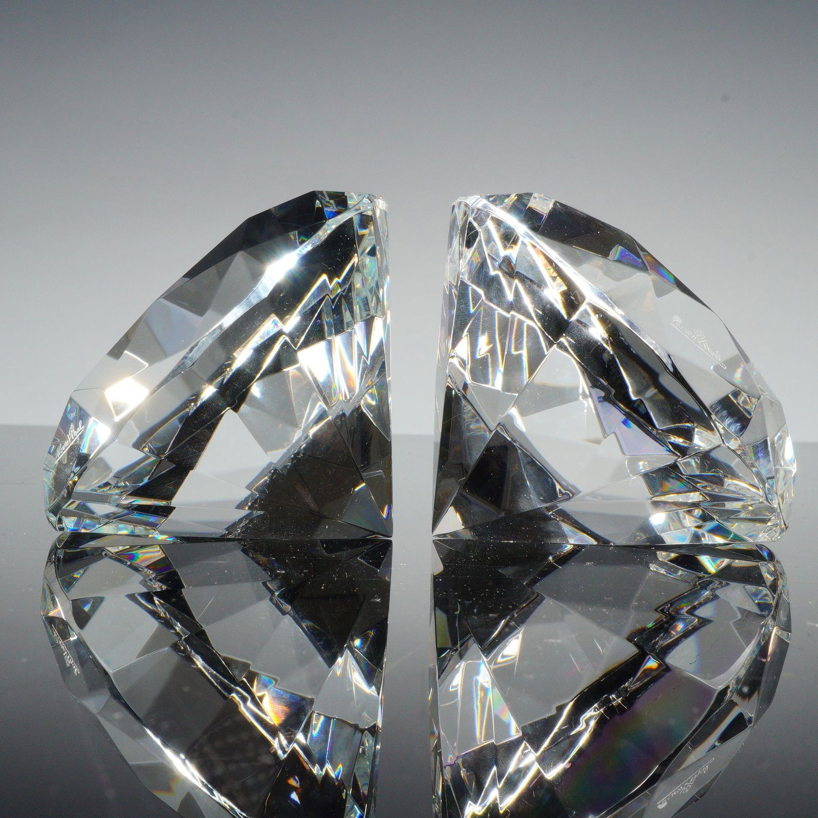 2pc Rosenthal Crystal Diamond Paperweights: Two clear crystal diamond-form paperweights by Rosenthal. Each finely cut with multiple faceted planes producing prismatic reflection and depth. Both marked Rosenthal on the base. Dimensions: Each pap
