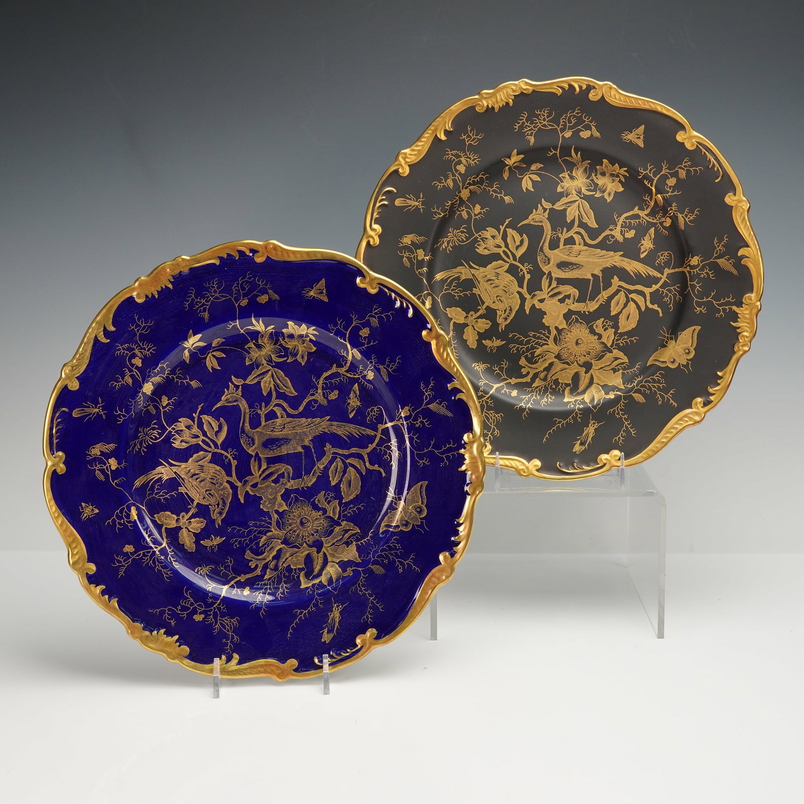 2pc Coalport Bone China Cabinet Plates, Cairo: Each exquisitely decorated in gilt chinoiserie motif portraying stylized birds amid flowering branches and delicate foliage. One example displays a deep cobalt blue ground while the other is finished 