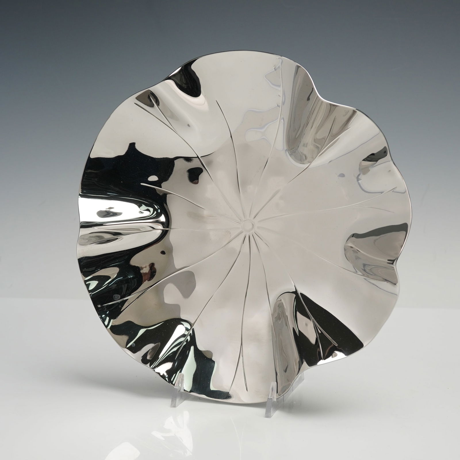 Michael Aram Signature Cast Metal Bowl-Lotus: A sculptural bowl crafted in the artist's distinctive organic style. The piece is designed as a lotus leaf form with fluid contours and a hand-finished reflective surface, made of cast metal as descri