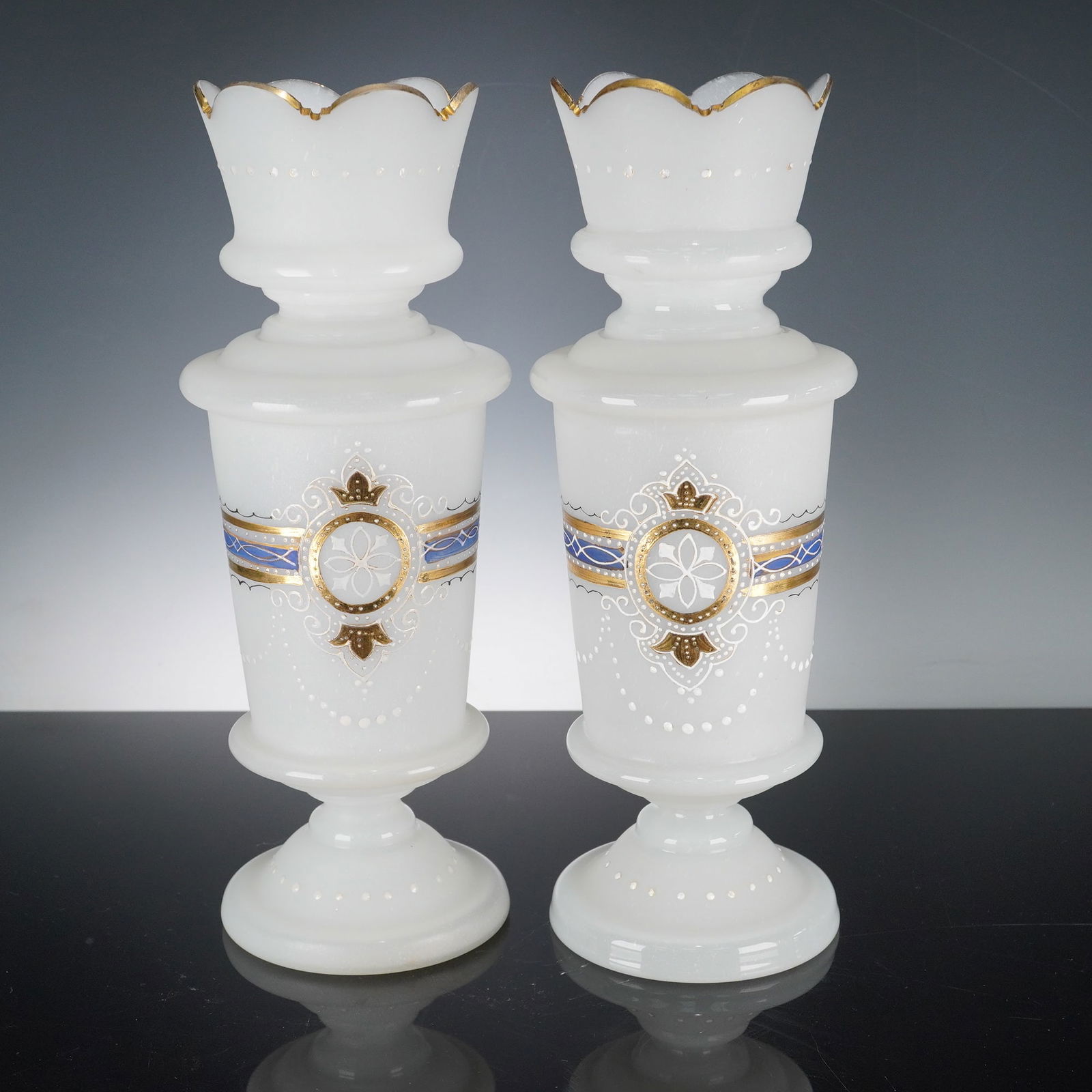 Pair of Bristol Glass White Satin-Finish Vases with Gilt Banding: A refined pair of white semi-opaque glass vases attributed to the Bristol glass tradition. Each stands approximately 12 inches high, executed in a satin-finished glass body and bearing hand-painted co