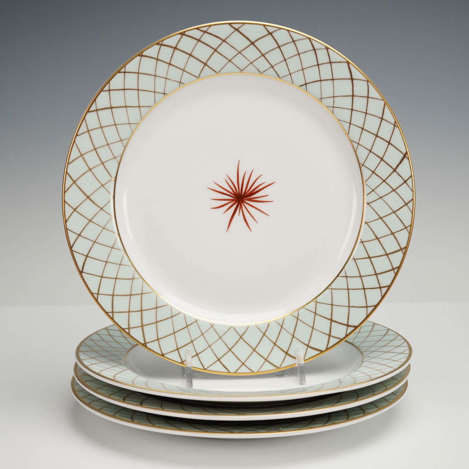 4pc Bernardaud Salad Plates, Etoile: A set of four Bernardaud Etoile salad plates with a pale green rim covered in a gilded lattice pattern, each finished with a thin gold colored edge and centered by a rust colored flower on a white bac