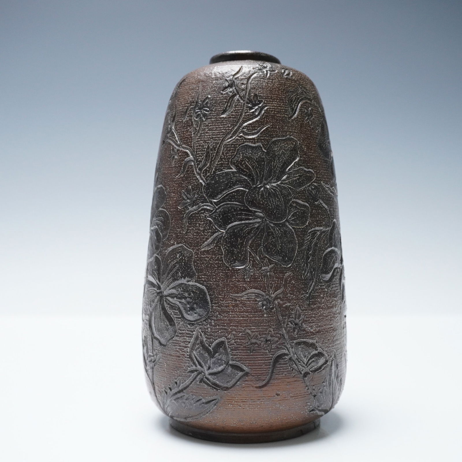 Martin Brothers Salt Glazed Stoneware Floral Vase: Salt glazed stoneware vase by Martin Brothers, featuring an incised floral design in relief across the entire surface. The ovoid form is hand-incised with climbing and spreading flowering vines, with