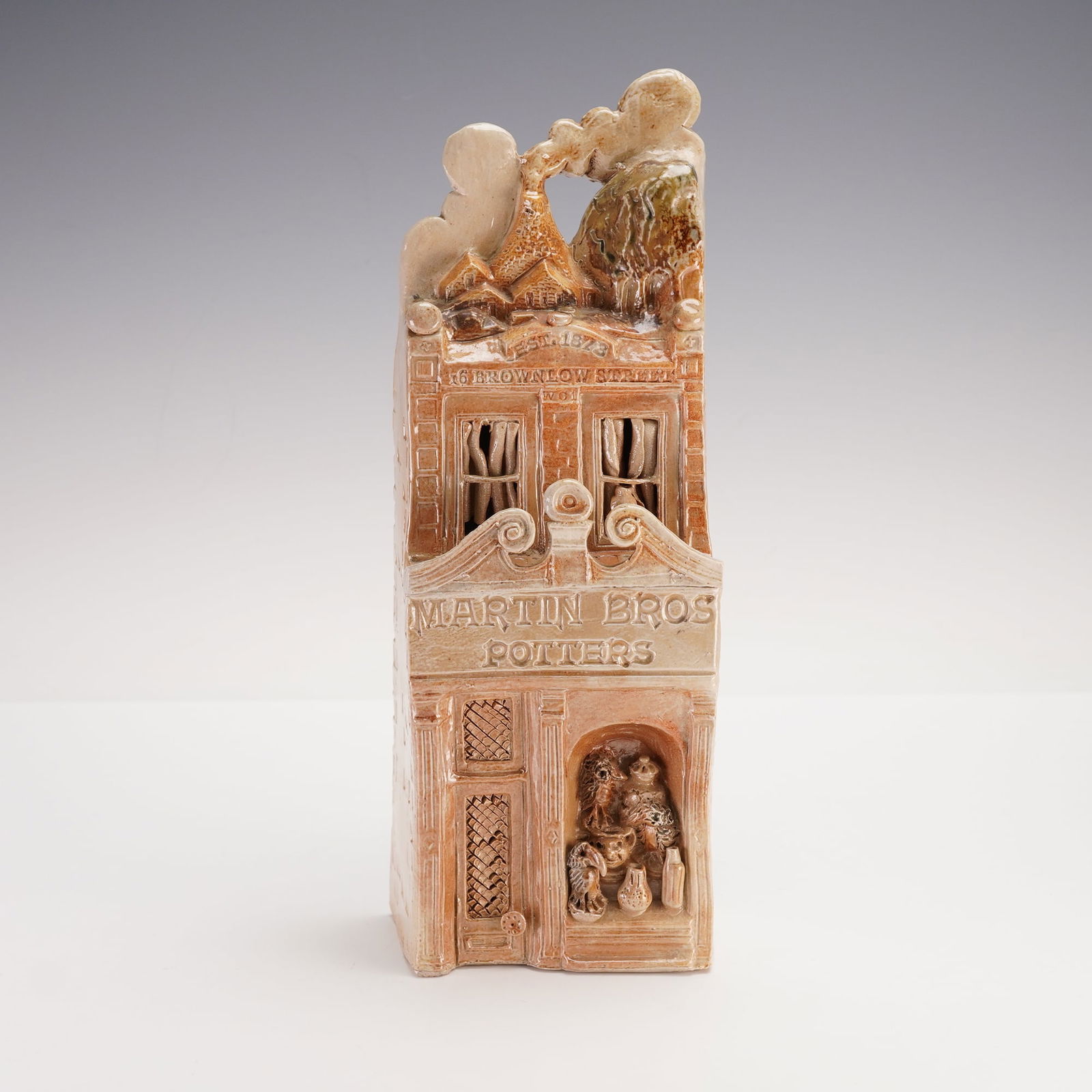 Salt Glazed Stoneware Model of the Martin Brothers Shop Invitation: Crafted in 1978, this piece was commissioned by Richard Dennis to invite Geraldine Norman to a private preview of the exhibition The Martin Brothers Potters at Sothebys Belgravia. The model exquisitel